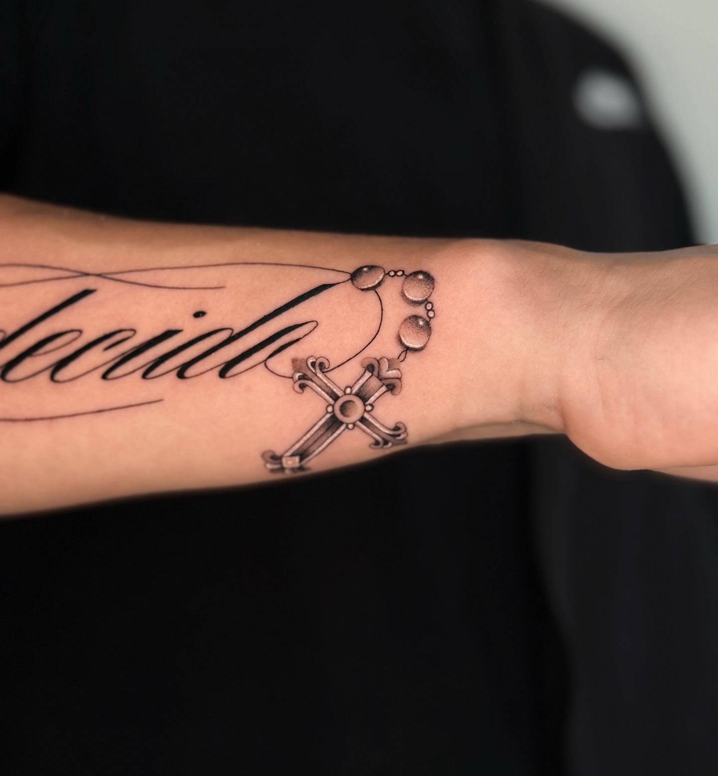 Cross and rosary black and grey tattoo on the forearm by Miami Tattoo Artist, Miami, Florida