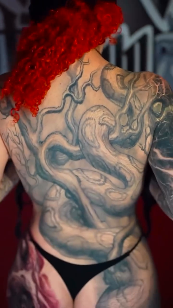 Serpentine forms realism tattoo by Paul Booth