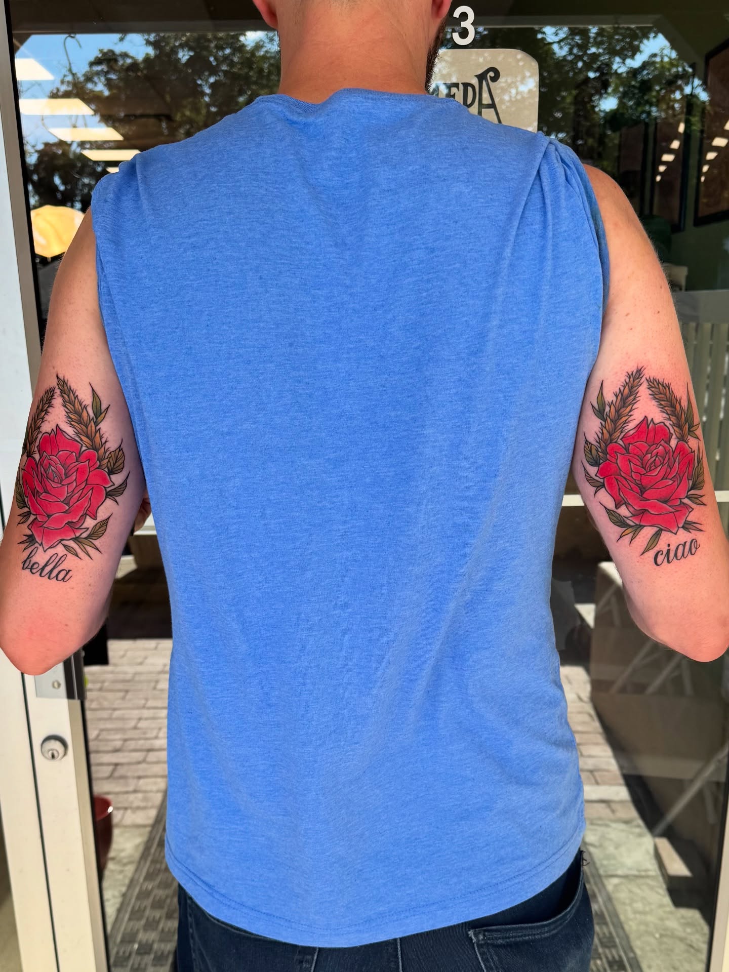 Red roses American traditional tattoo on the upper arm by Michael Langdale
