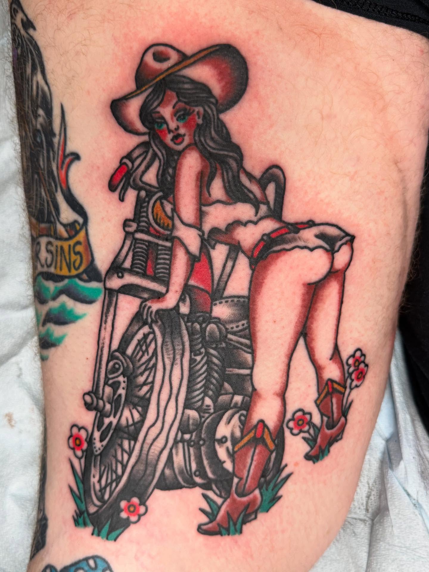 Motorcycle pin-up girl American traditional tattoo on the thigh by Bill Crawford, Plymouth, Michigan