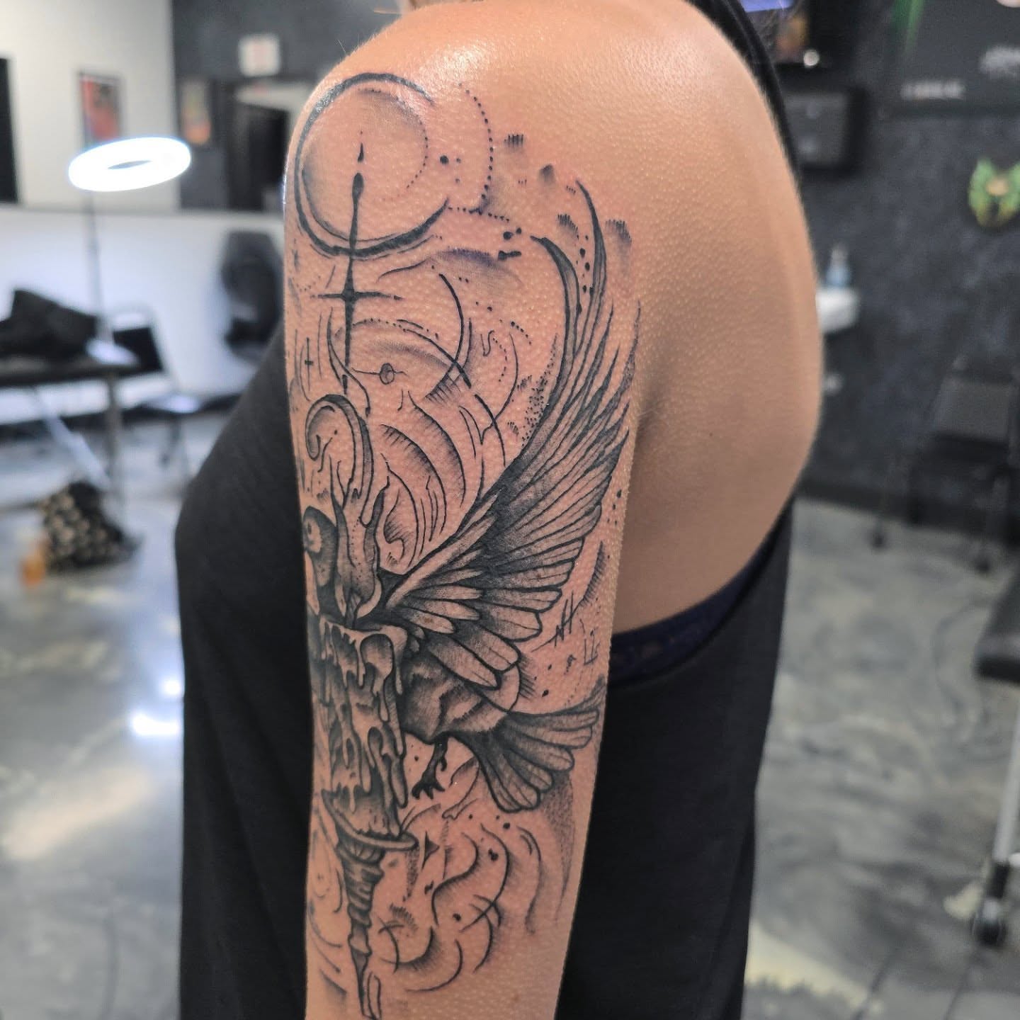 Winged skull with candle realism tattoo on the upper arm by Jon Griffin, Maryville, Tennessee