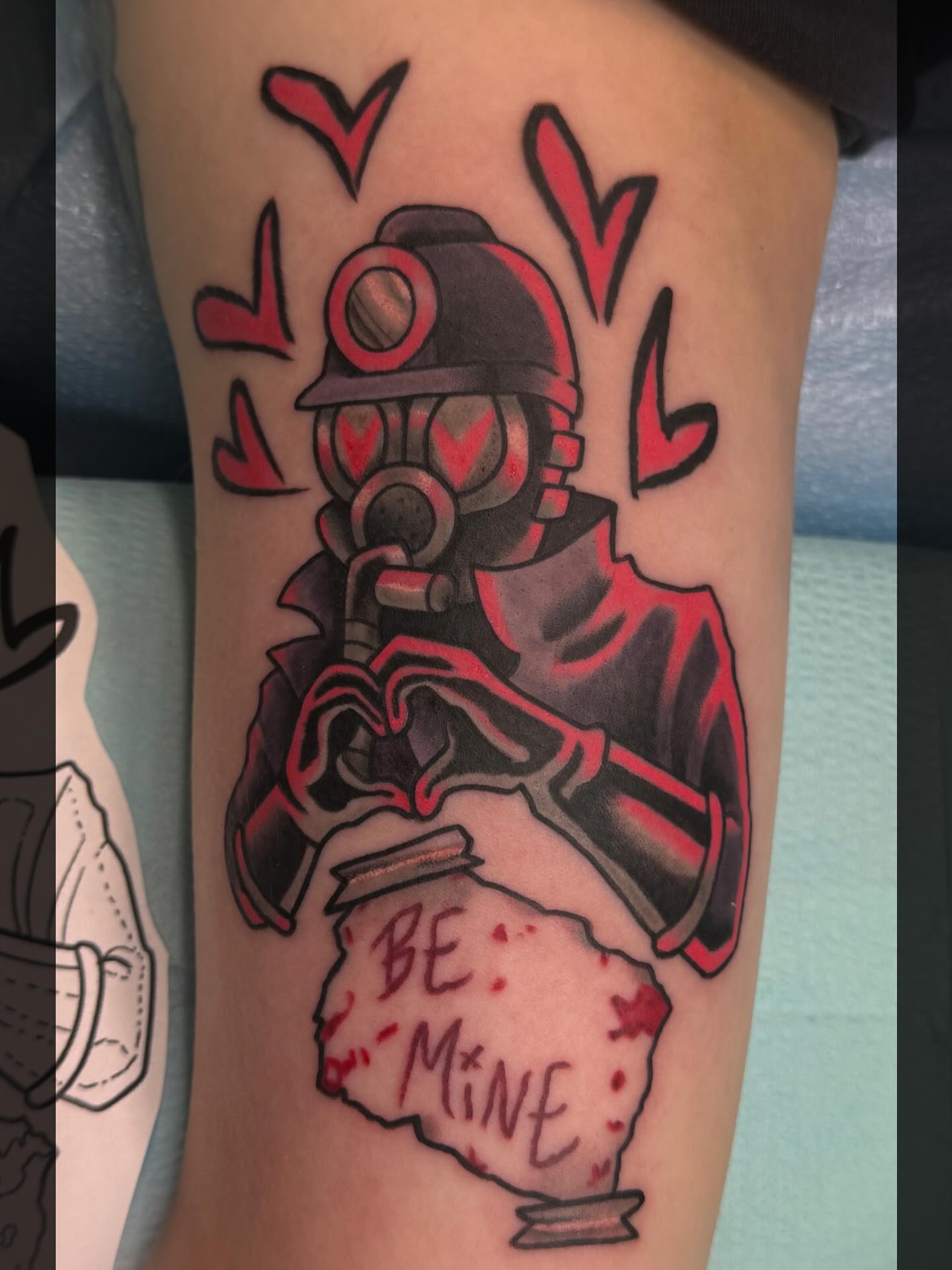 Gas mask with heart American traditional tattoo on the forearm by Romans