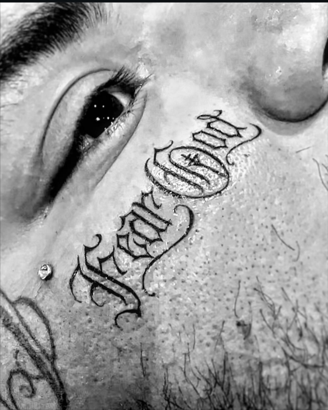 Fear lettering script tattoo on the chest by F e A R