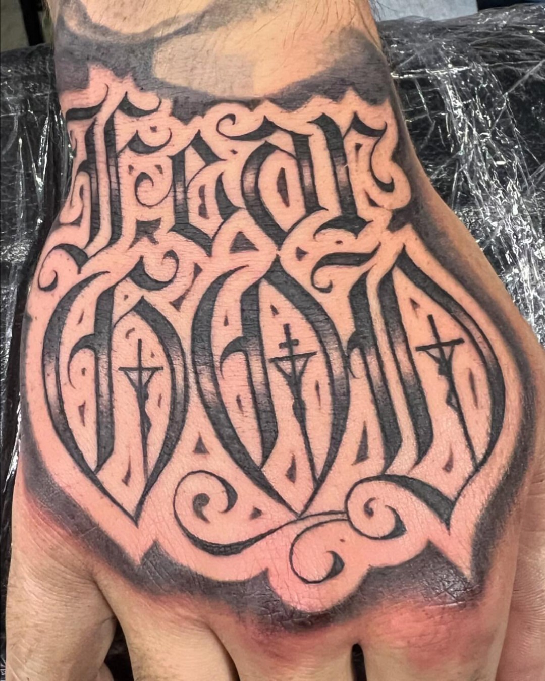 Religious script lettering script tattoo on the hand by F e A R