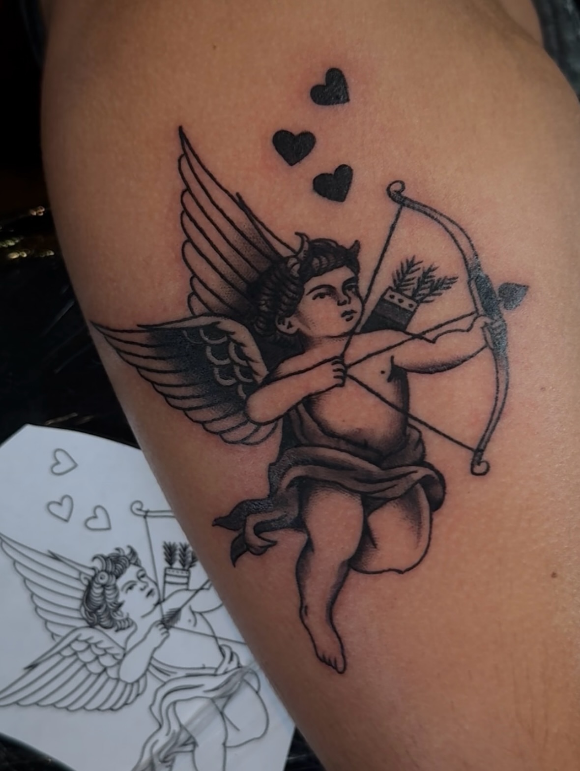 Cupid with bow and arrow black and grey tattoo on the thigh by Cory Allen