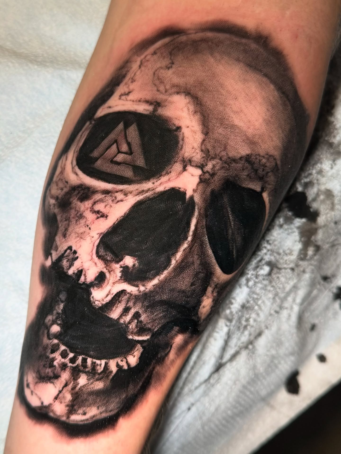 Skull realism tattoo on the forearm by John Black