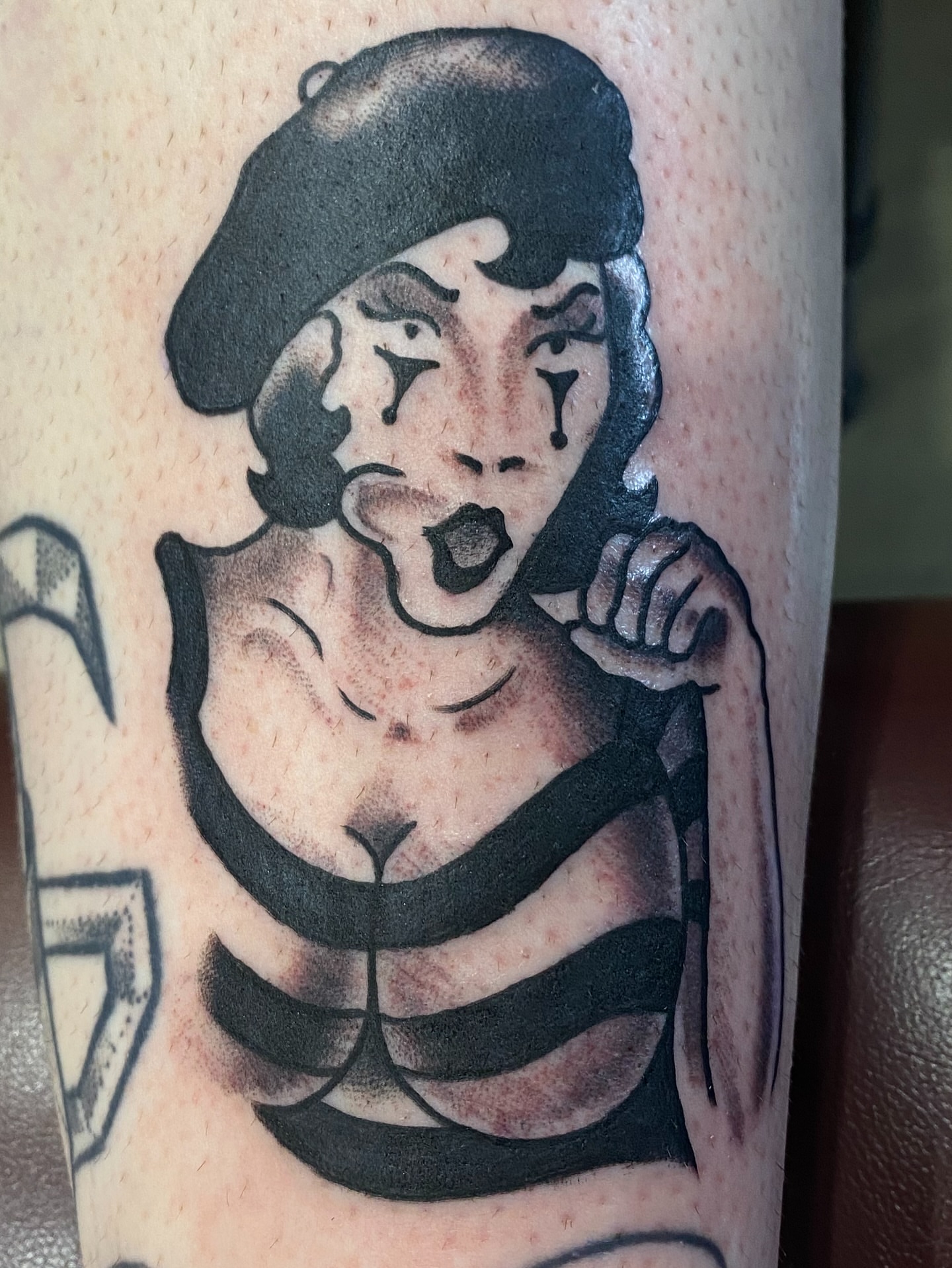 Woman in beret black and grey tattoo on the forearm by John Black