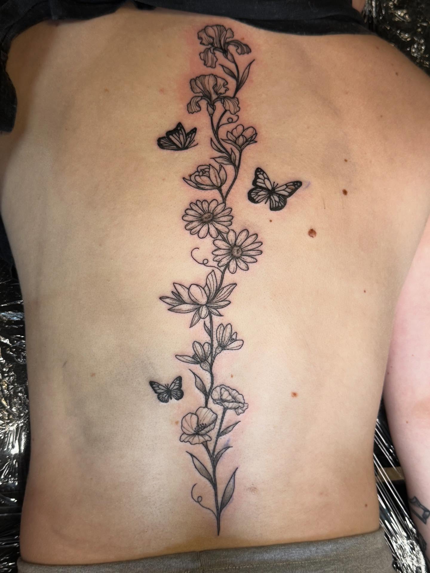 Floral vine with butterflies black and grey tattoo on the back by Mickey