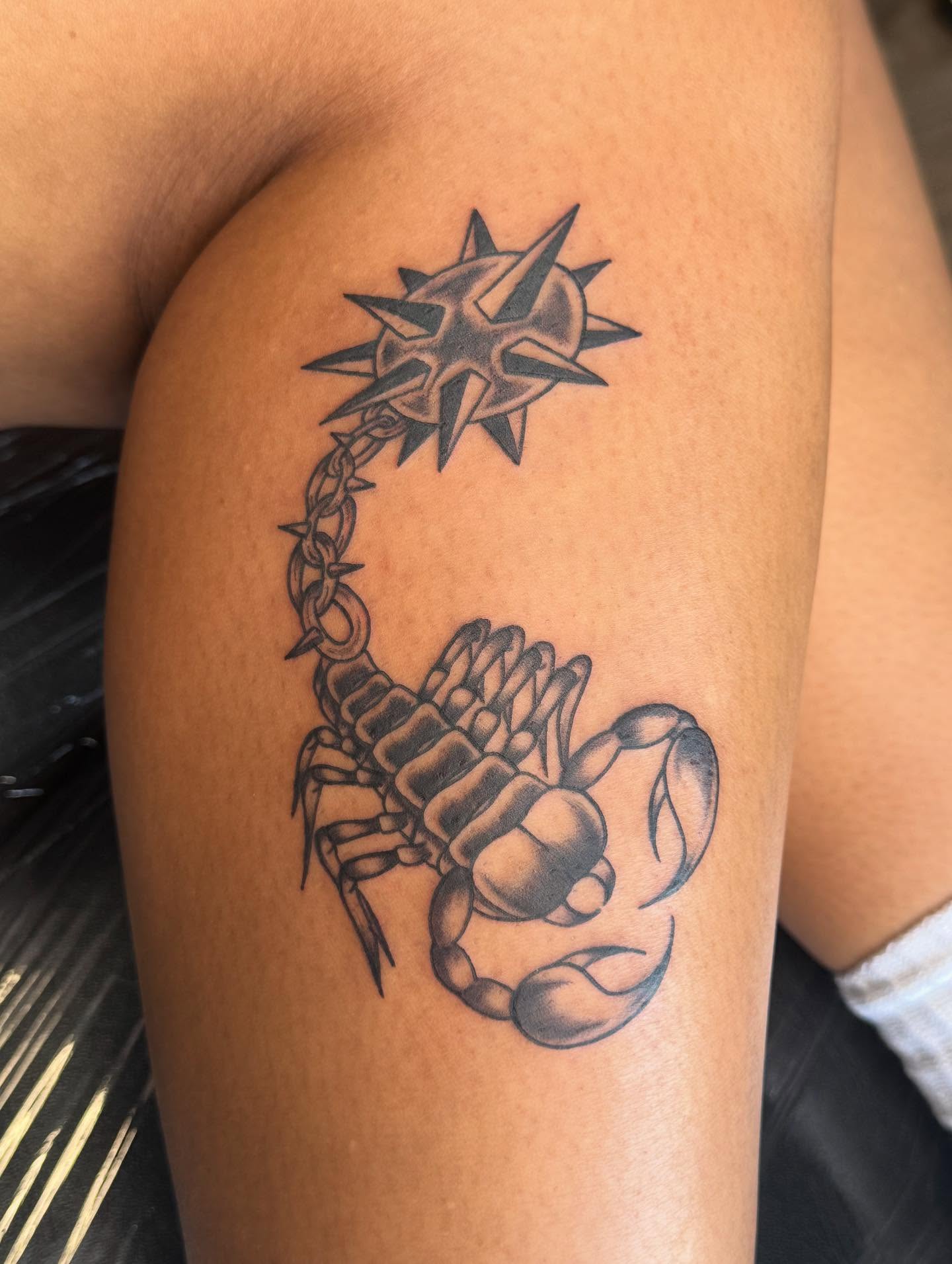 Scorpion black and grey tattoo on the thigh by Mickey