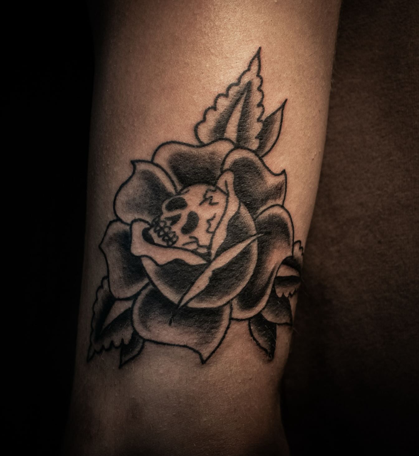 Rose with skull American traditional tattoo on the forearm by savannah