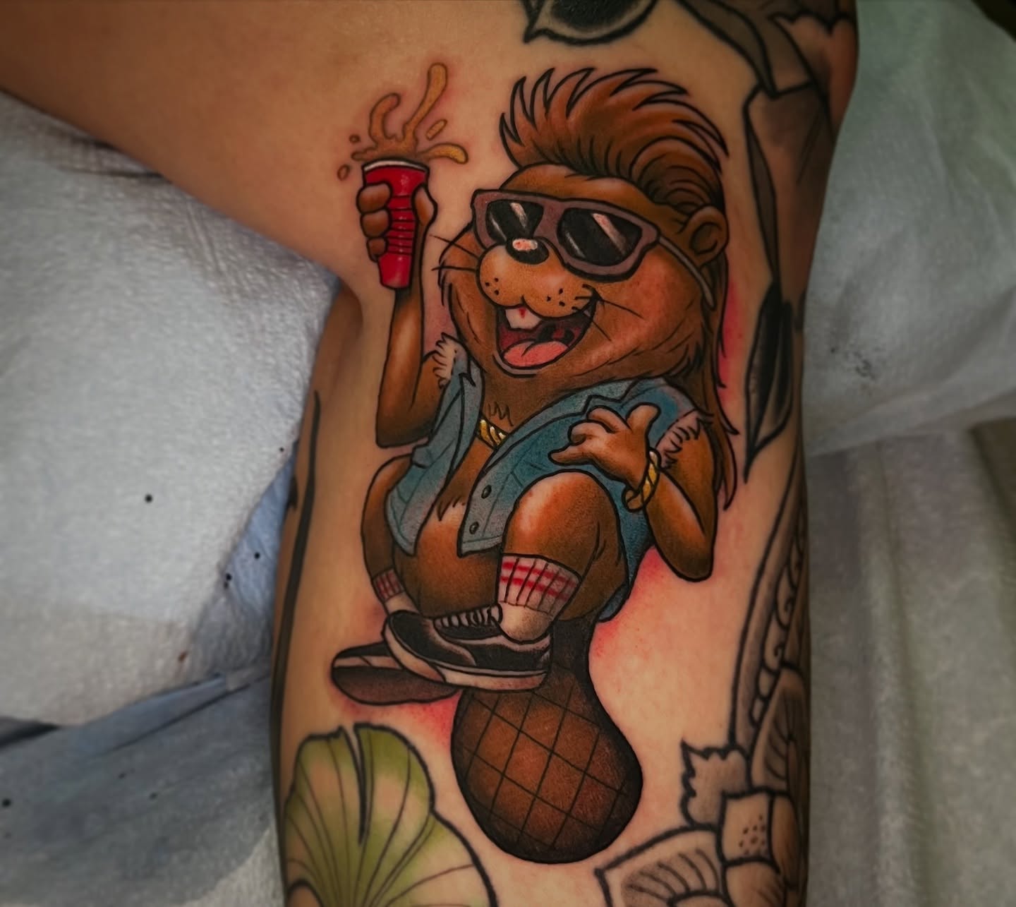 Lion with sunglasses new school tattoo on the forearm by Evan Perrine
