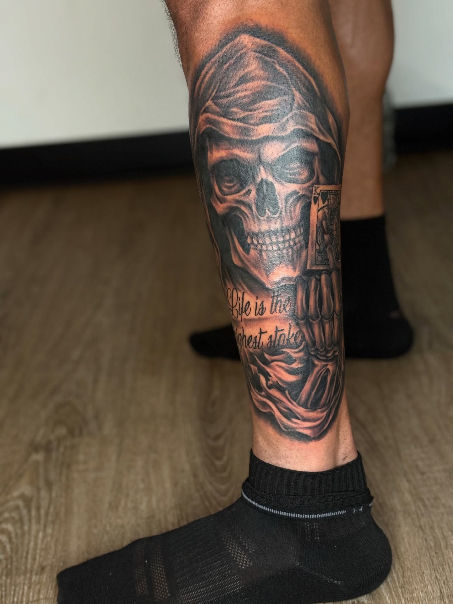 Skull with draped cloth realism tattoo on the calf by Vonte Seay