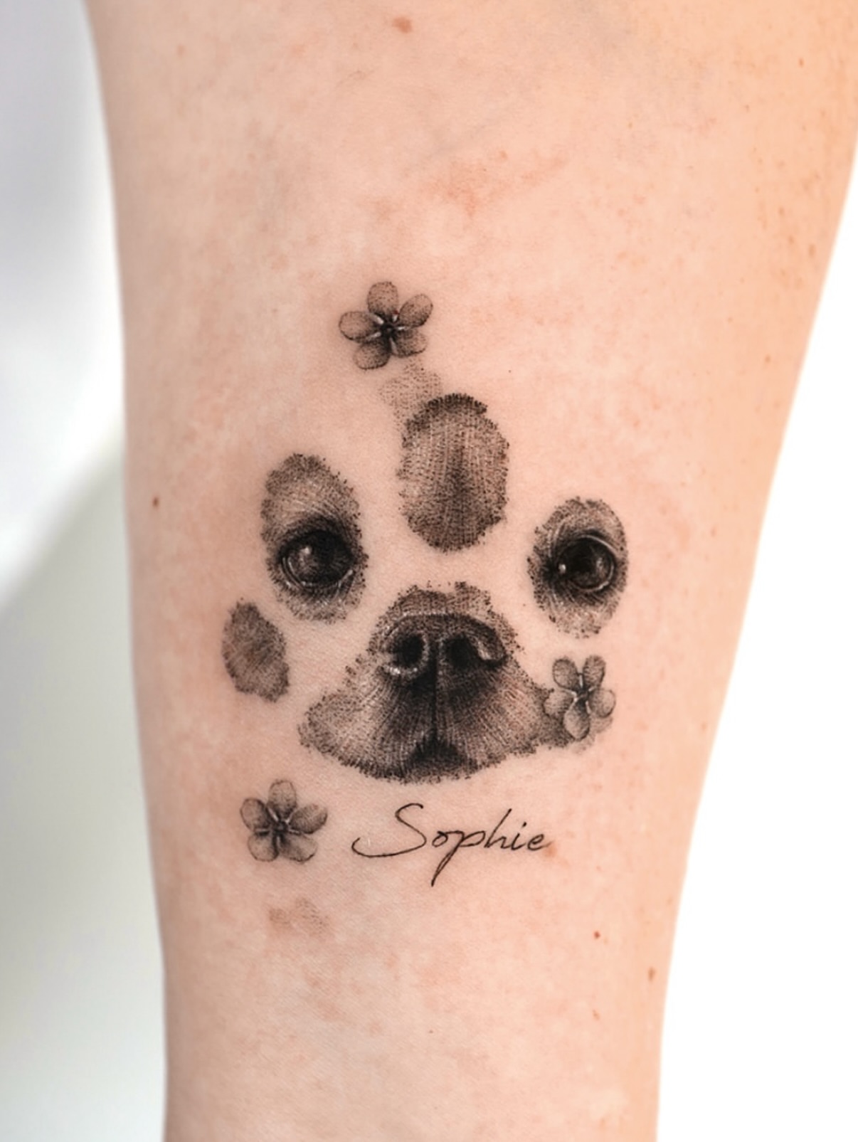 Dog paw print dotwork tattoo on the forearm by Ria Kim 김리아
