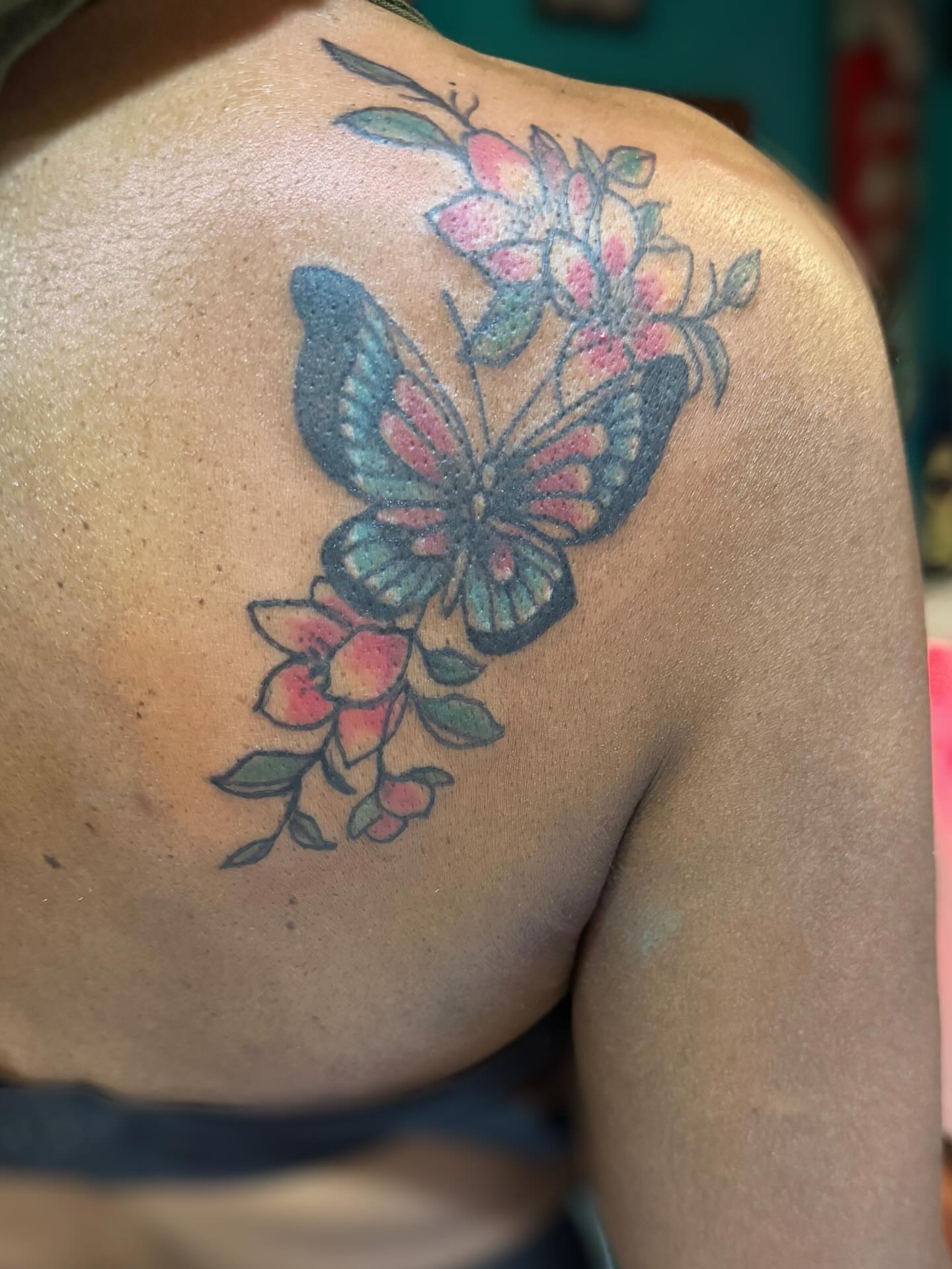 Butterfly and flowers American traditional tattoo on the shoulder by @brocks_tatt_attic_, New Orleans, Louisiana