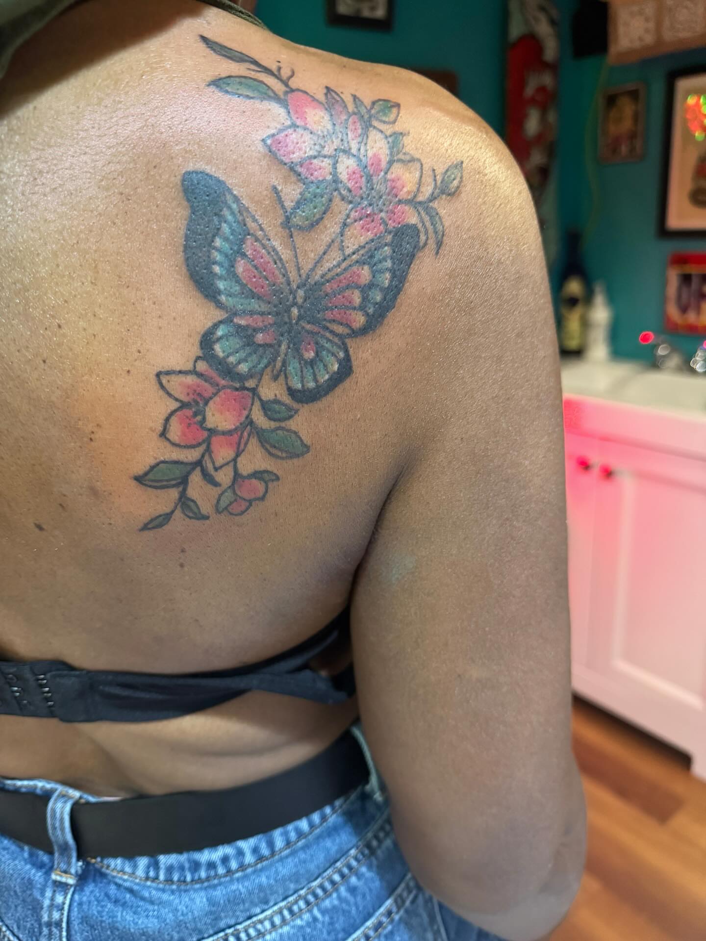 Butterfly and flowers American traditional tattoo on the shoulder by @brocks_tatt_attic_, New Orleans, Louisiana