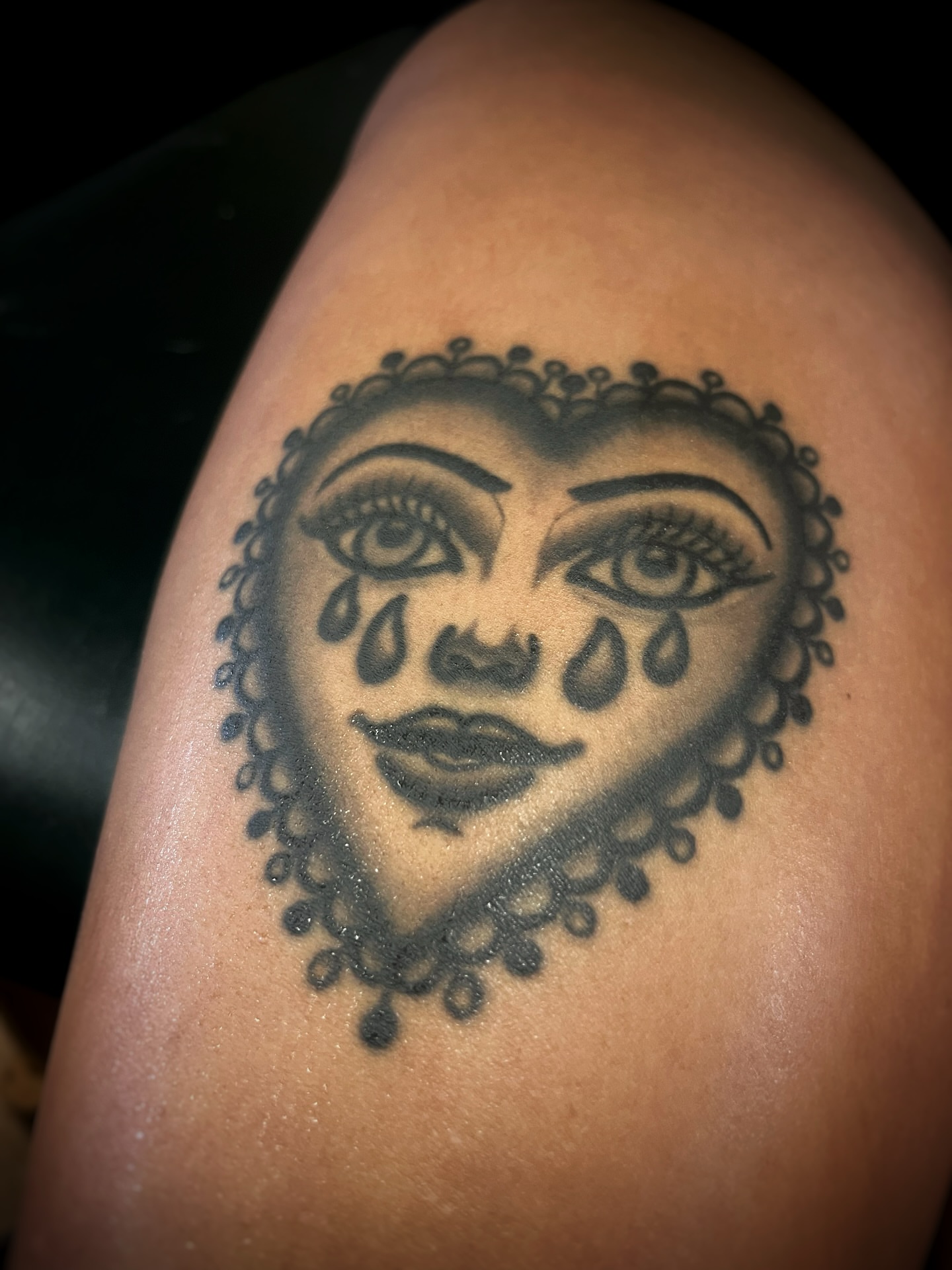 Tearful woman's face black and grey tattoo on the shoulder by Gilbert Gonzalez