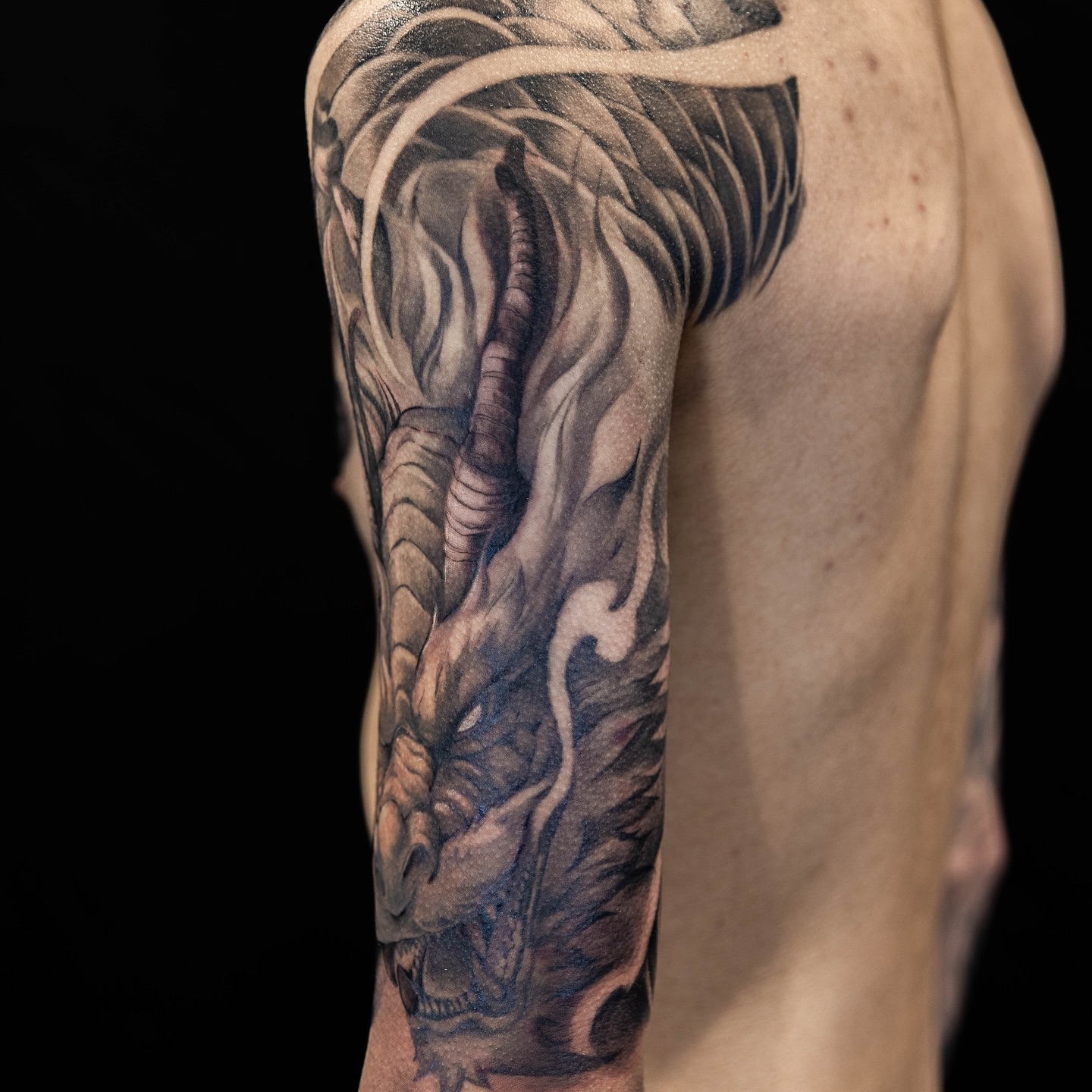 Dragon realism tattoo on the upper arm by LaurenBeez