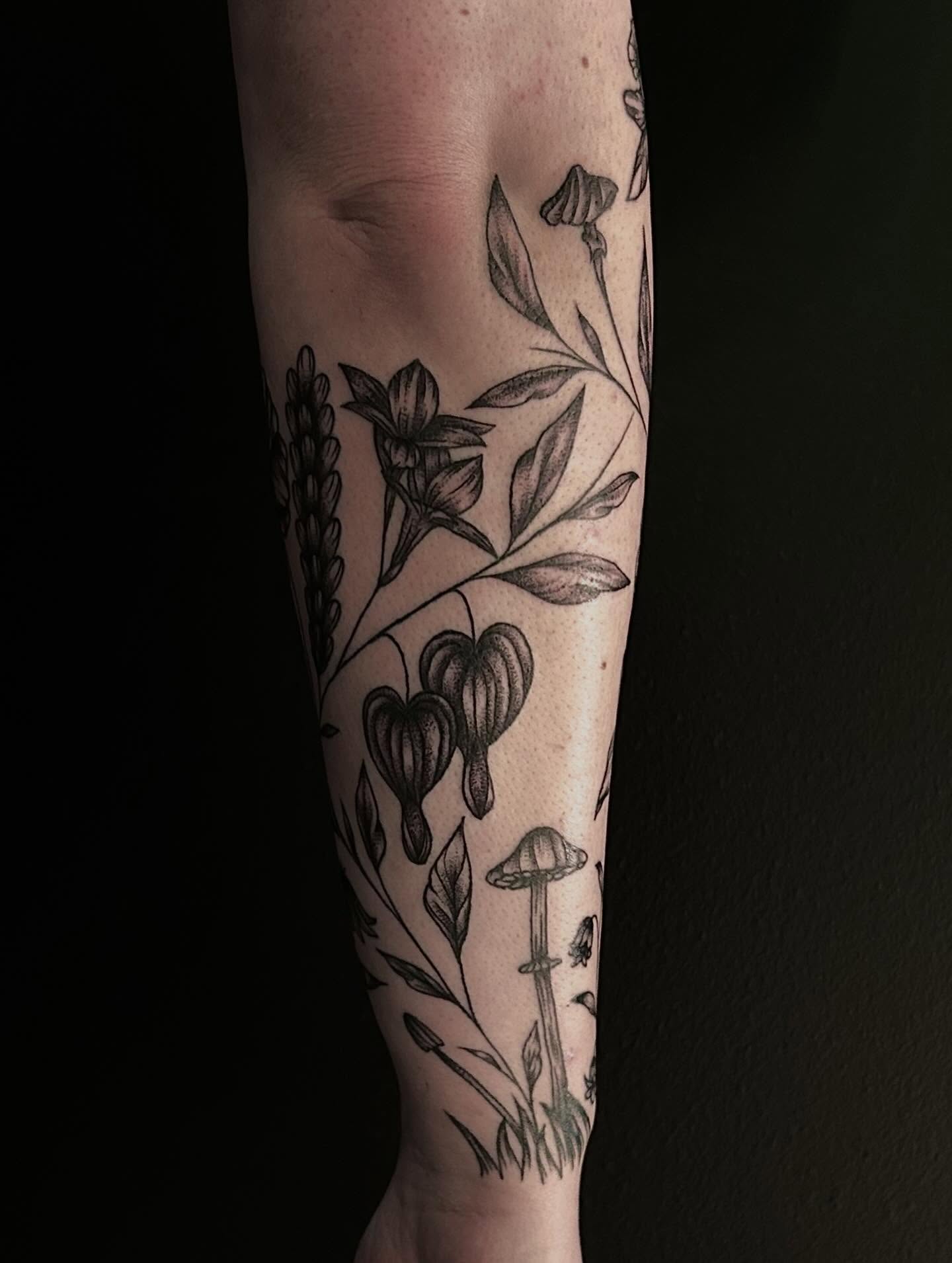 Botanical motifs black and grey tattoo on the forearm by Kenadee