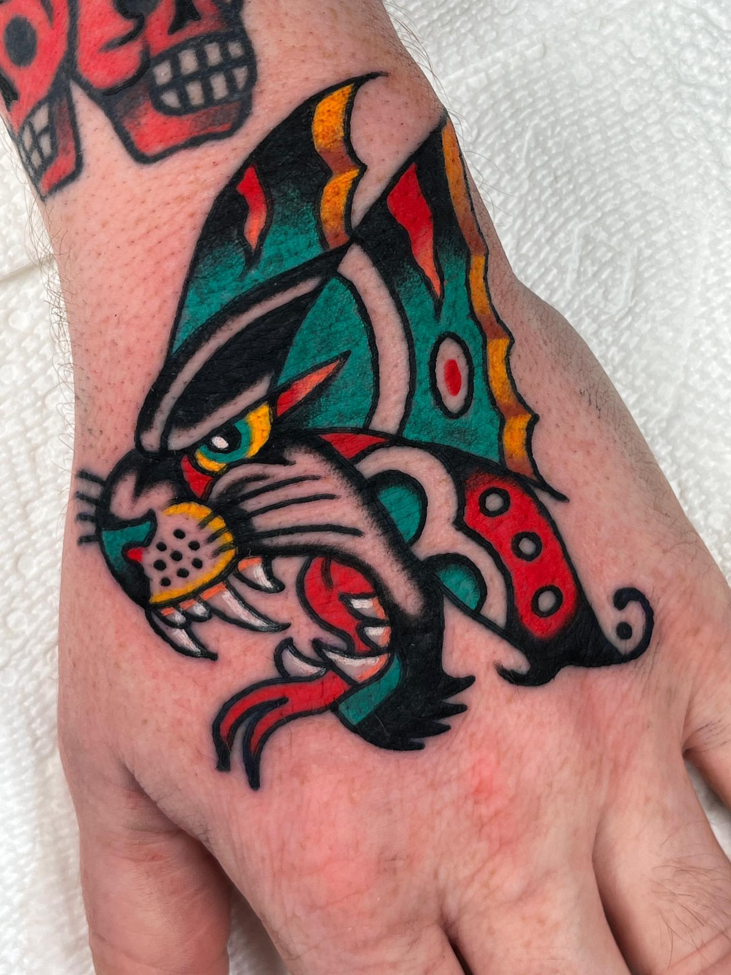 Panther American traditional tattoo on the hand by Charlie Ostrom, Durham, North Carolina