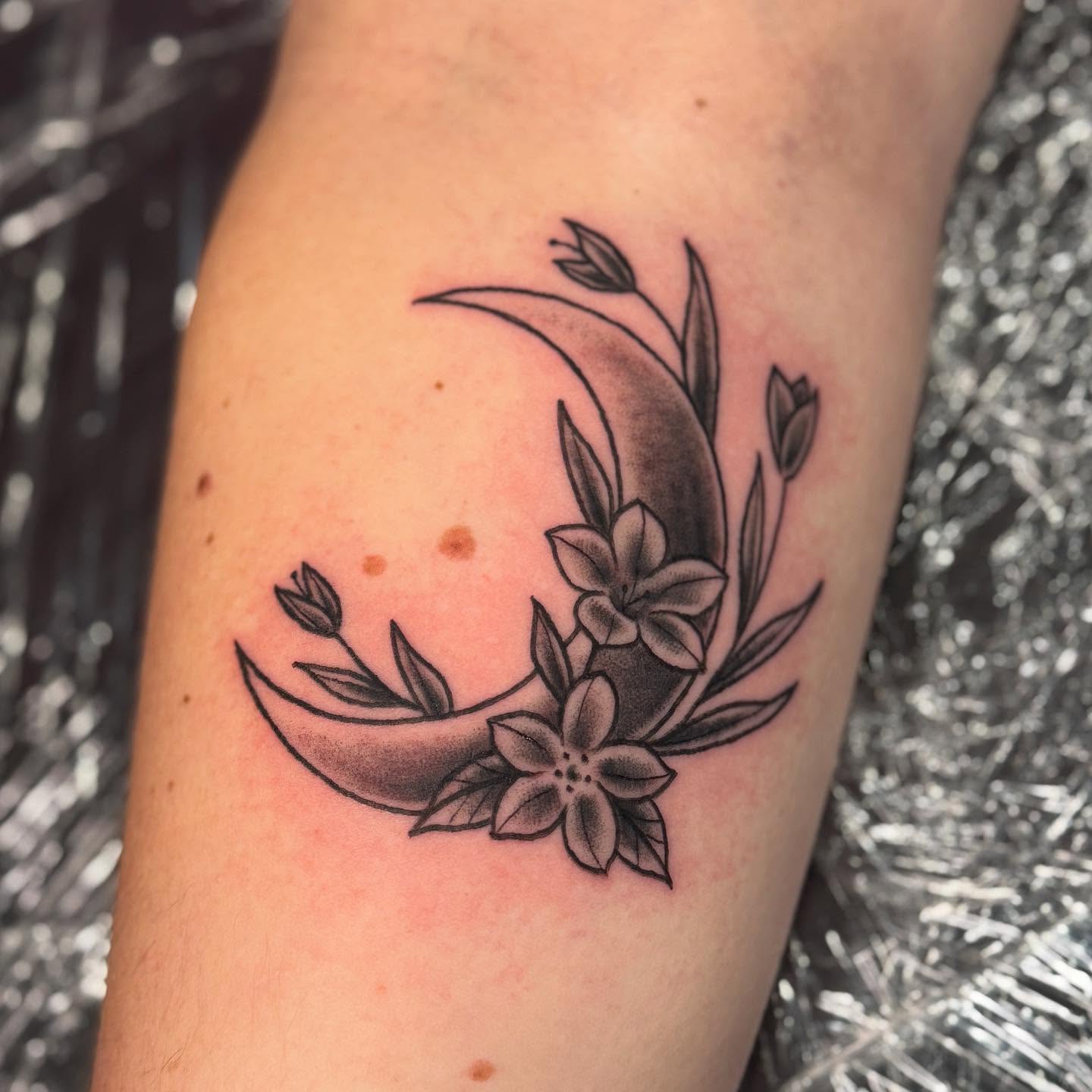 Moon and flowers black and grey tattoo on the forearm by Ashley Rose - Minnesota Tattoo Artist