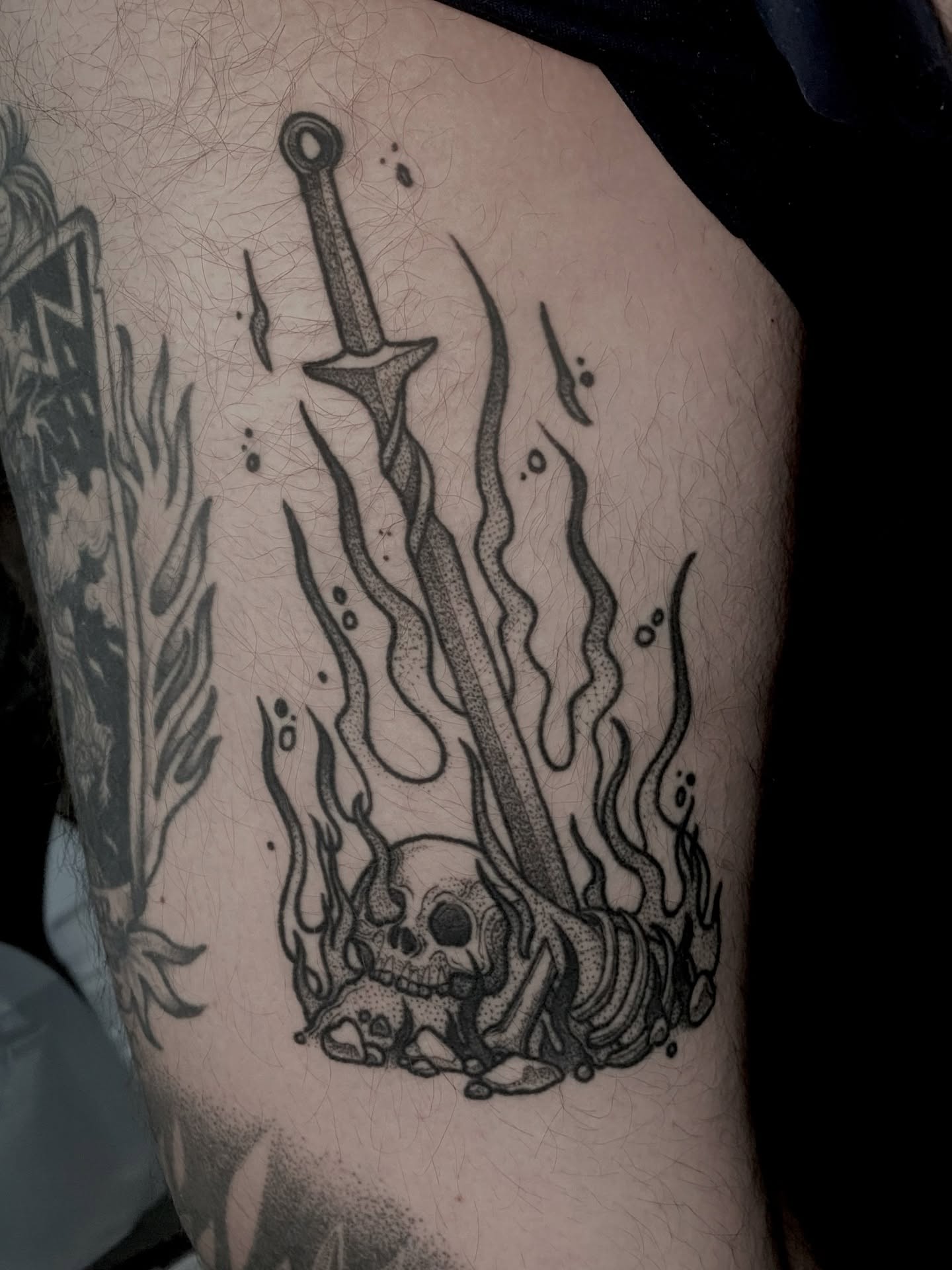 Sword and skull dark realism tattoo on the thigh by Rowan Starr