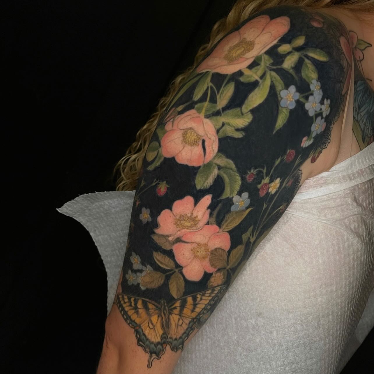 Floral bouquet realism tattoo on the upper arm by Paige Hudon, Chicago, Illinois