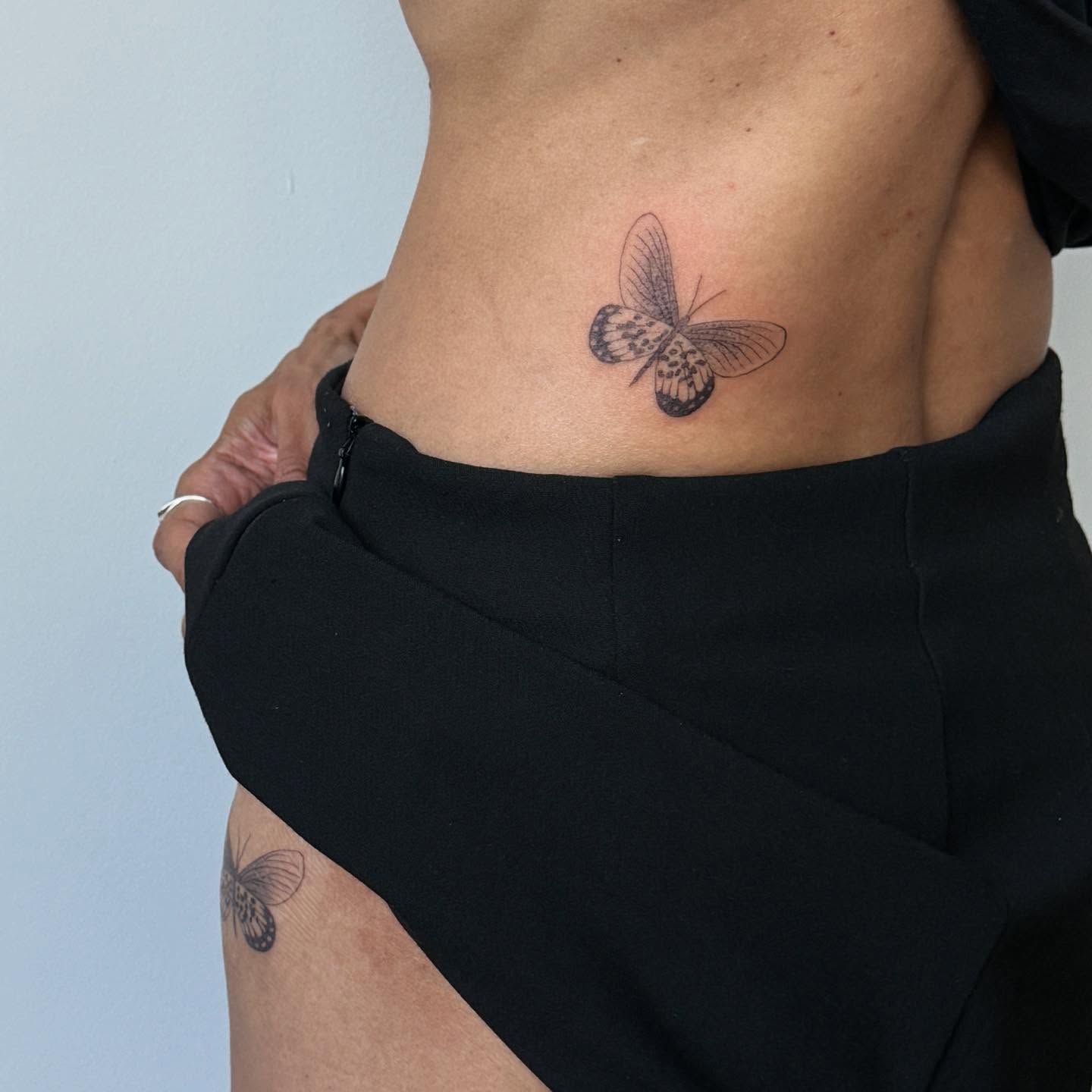 Butterfly black and grey tattoo on the torso by Kirsten
