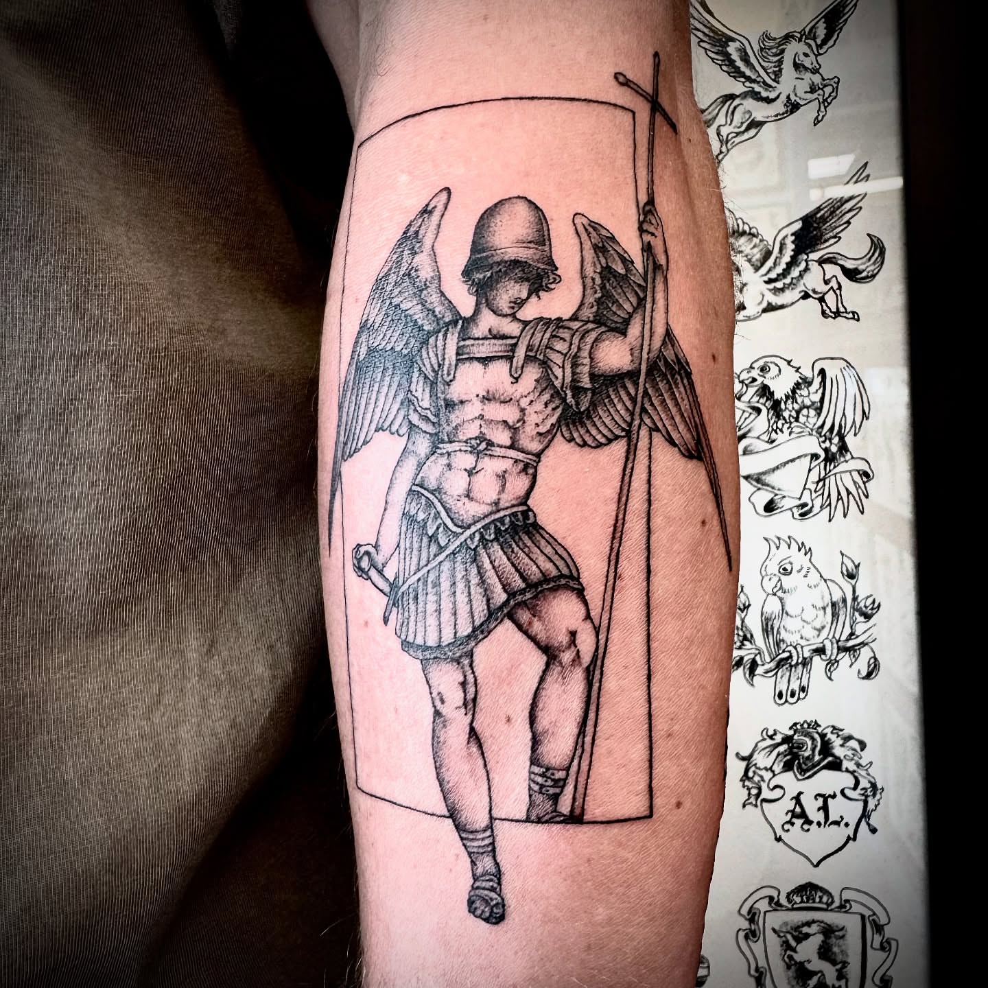 Angel with sword black and grey tattoo on the forearm by Kristen