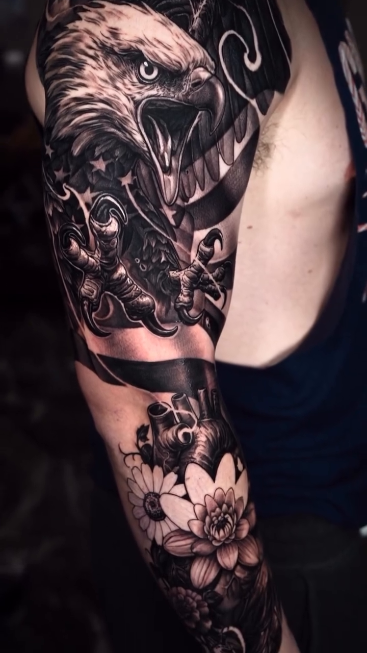 Eagle and lotus flowers realism tattoo by Jake Ross, Mentor, Ohio
