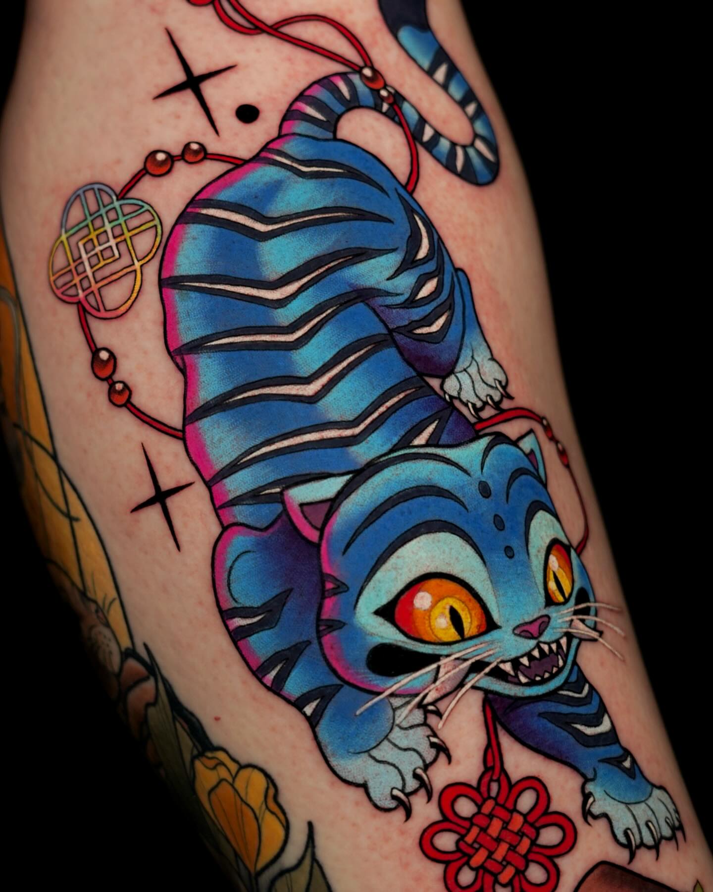 Blue tiger American traditional tattoo on the forearm by Brooke Borden