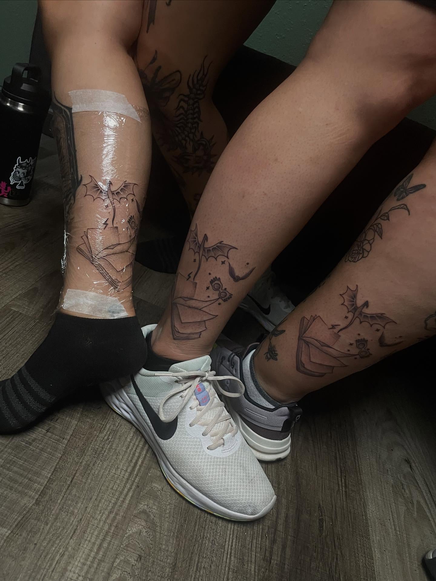 Book and bat black and grey tattoo on the leg by Marcus
