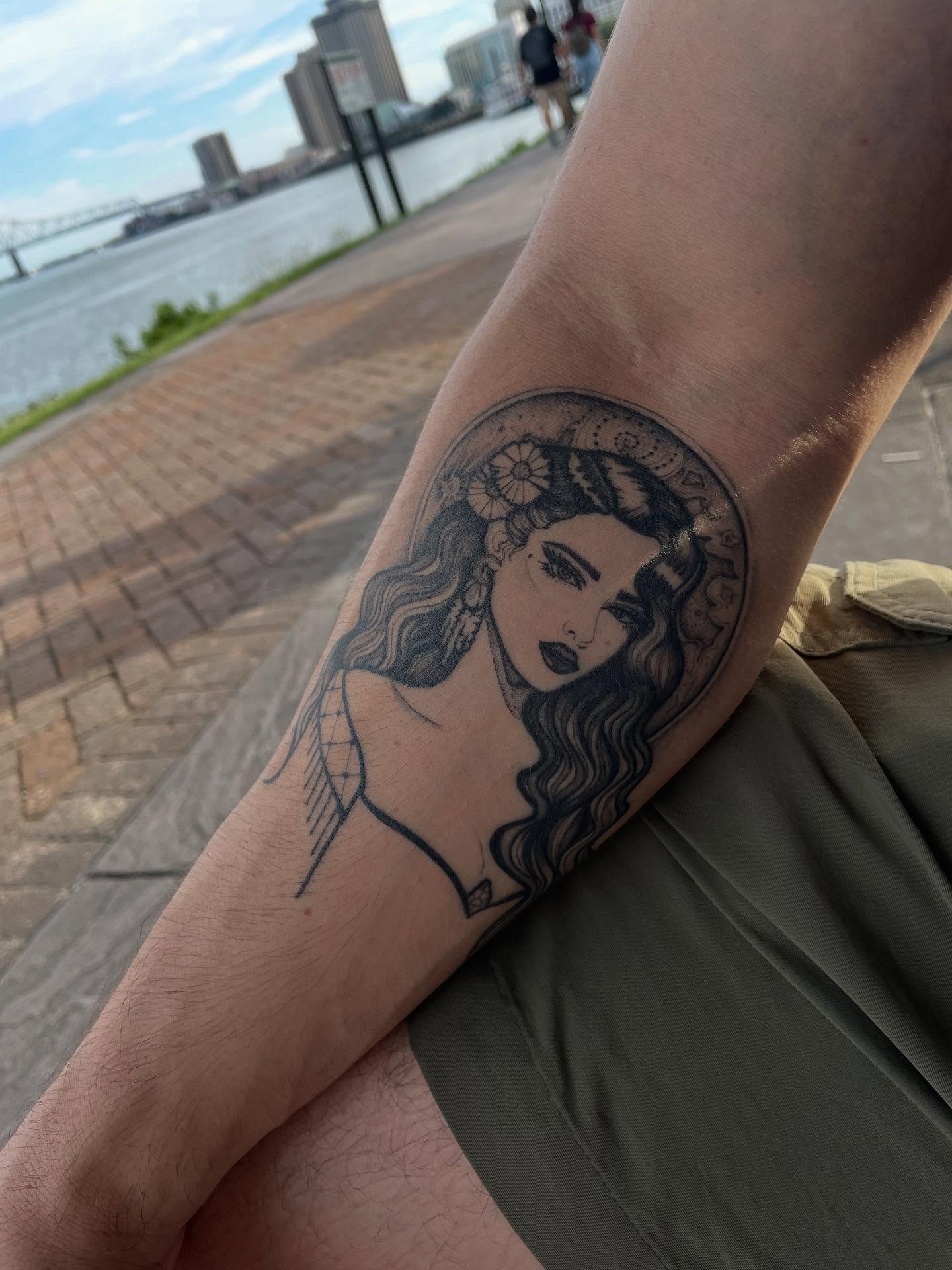 Woman with flowers black and grey tattoo on the forearm by Danika Brooke 🧿