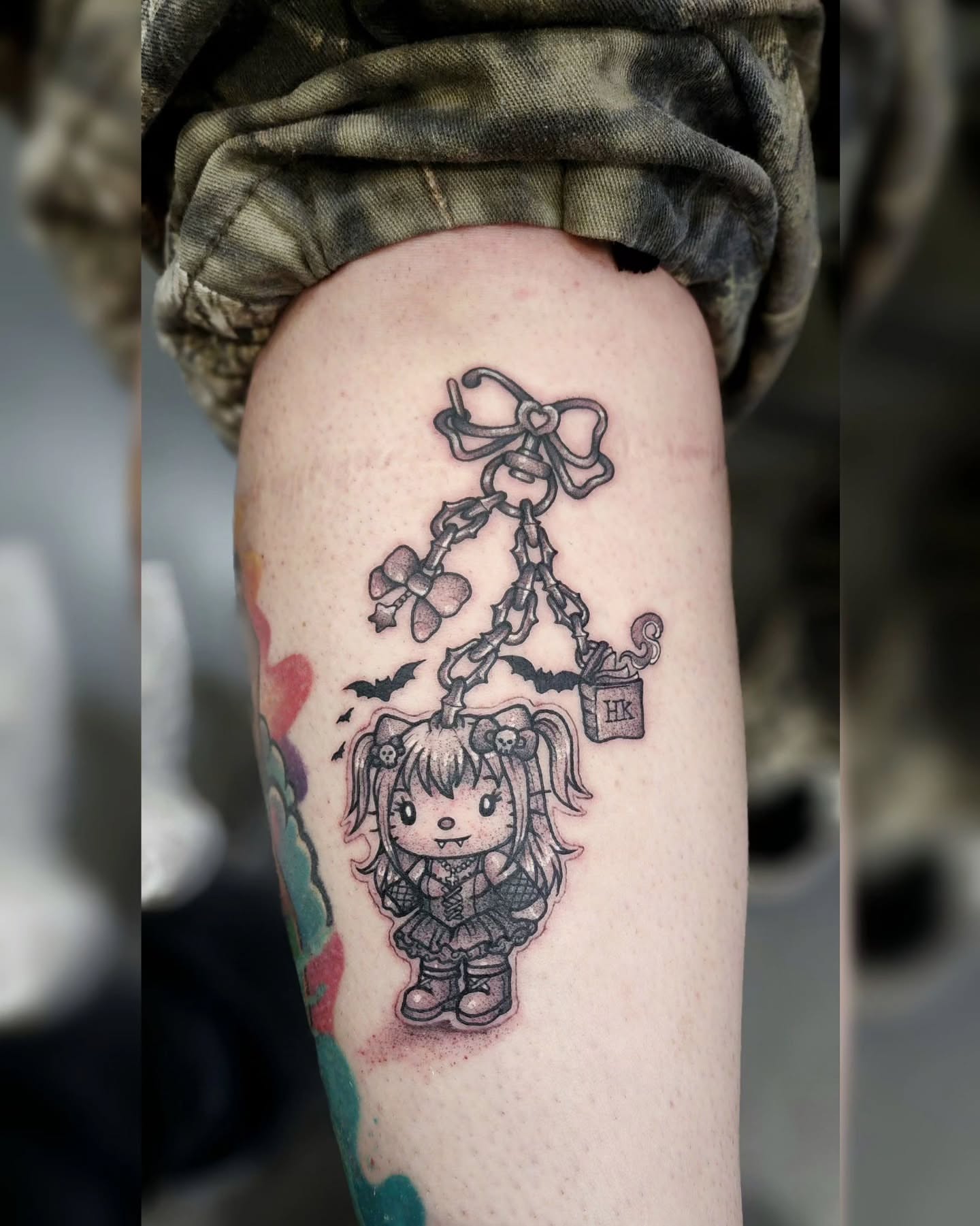 Doll black and grey tattoo on the forearm by Diane Maya