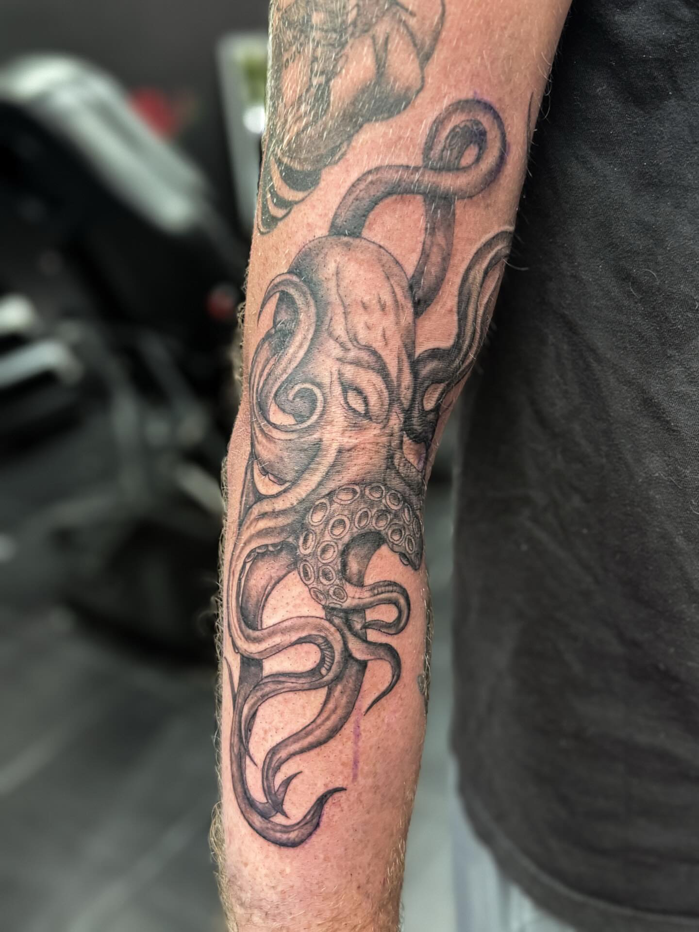 Octopus black and grey tattoo on the forearm by Rachel
