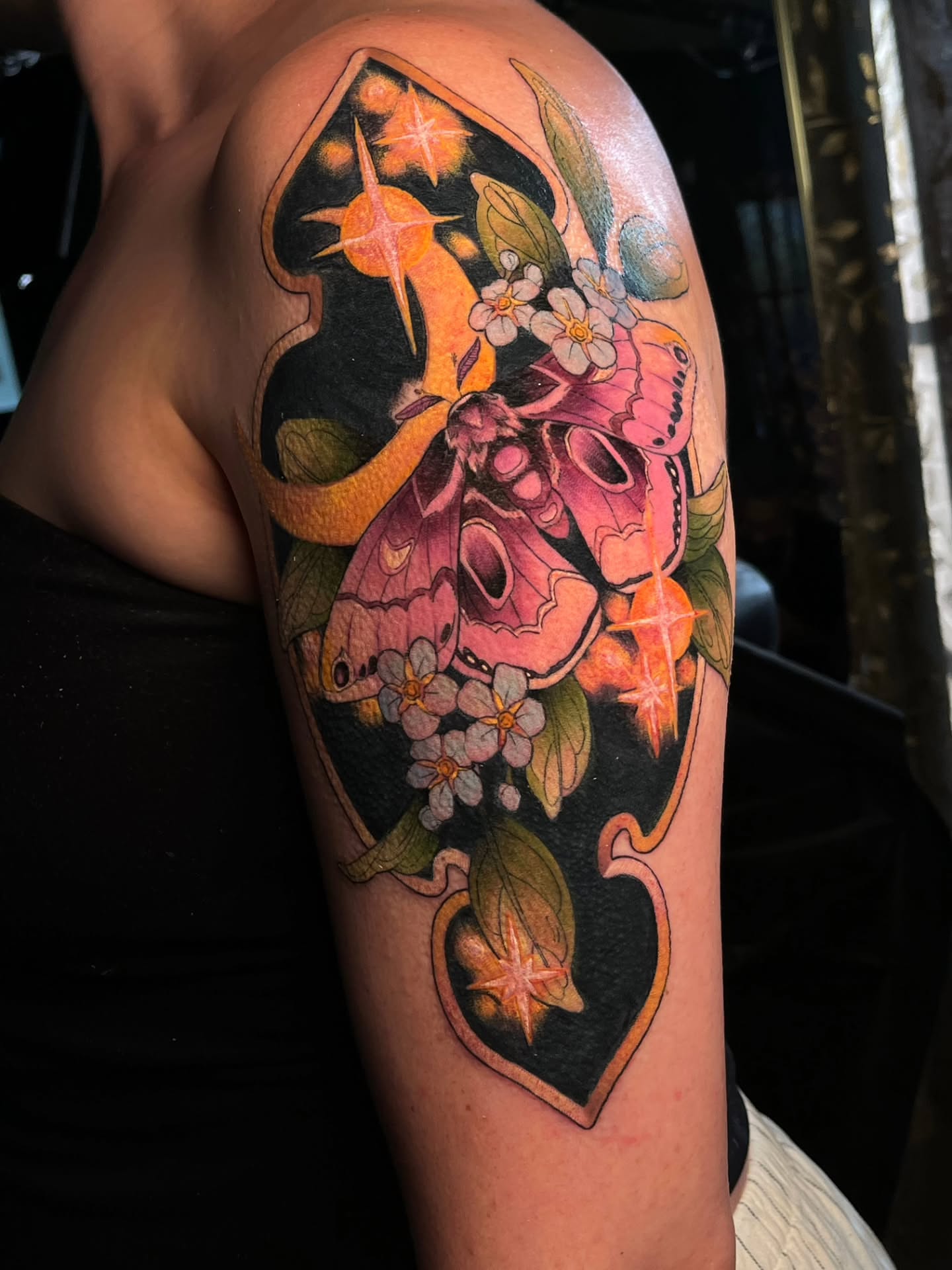 Moth and flowers realism tattoo on the upper arm by Summer Machelle, Orange, California