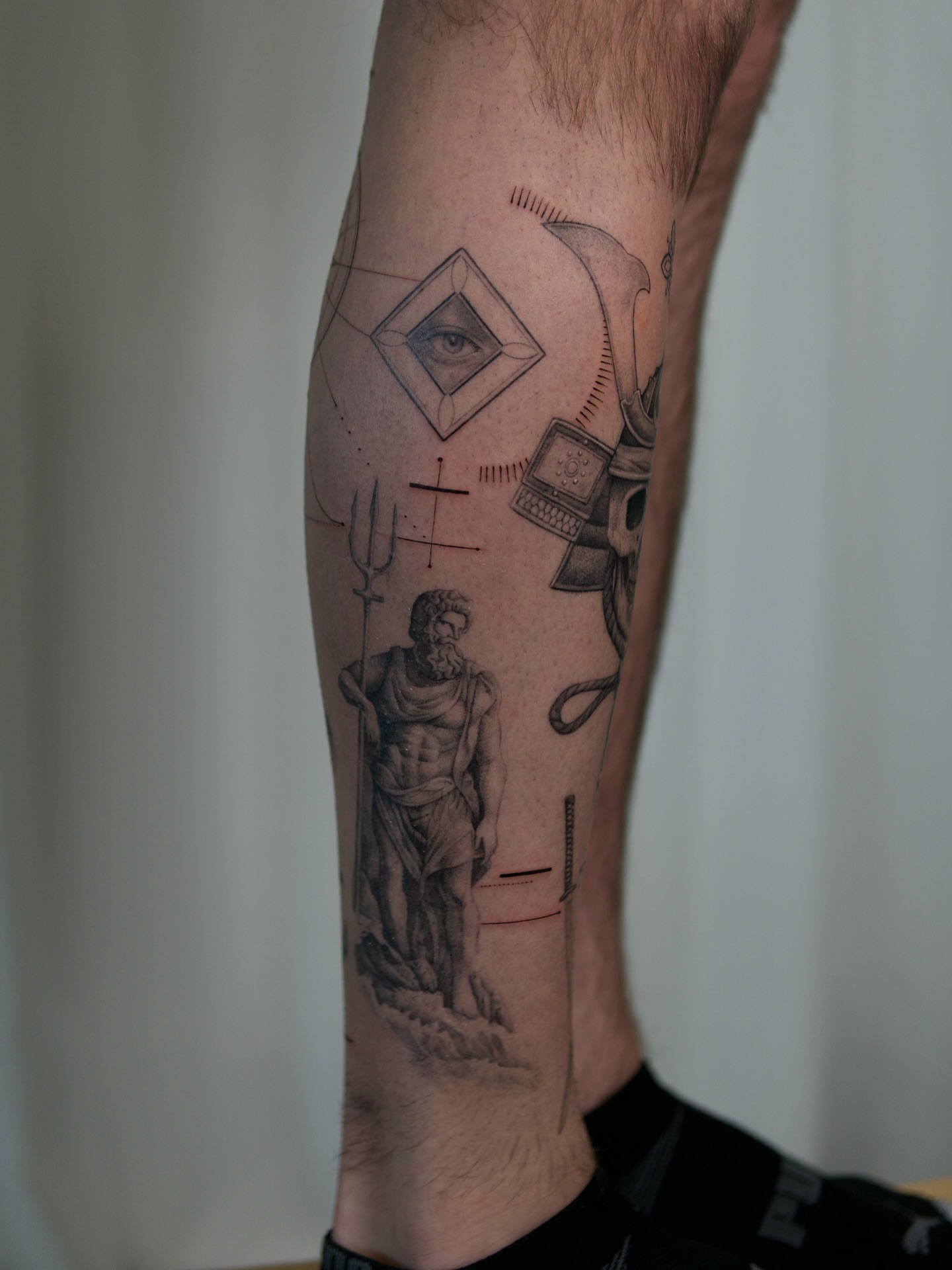Statue of Poseidon realism tattoo on the forearm by Ray Quinday