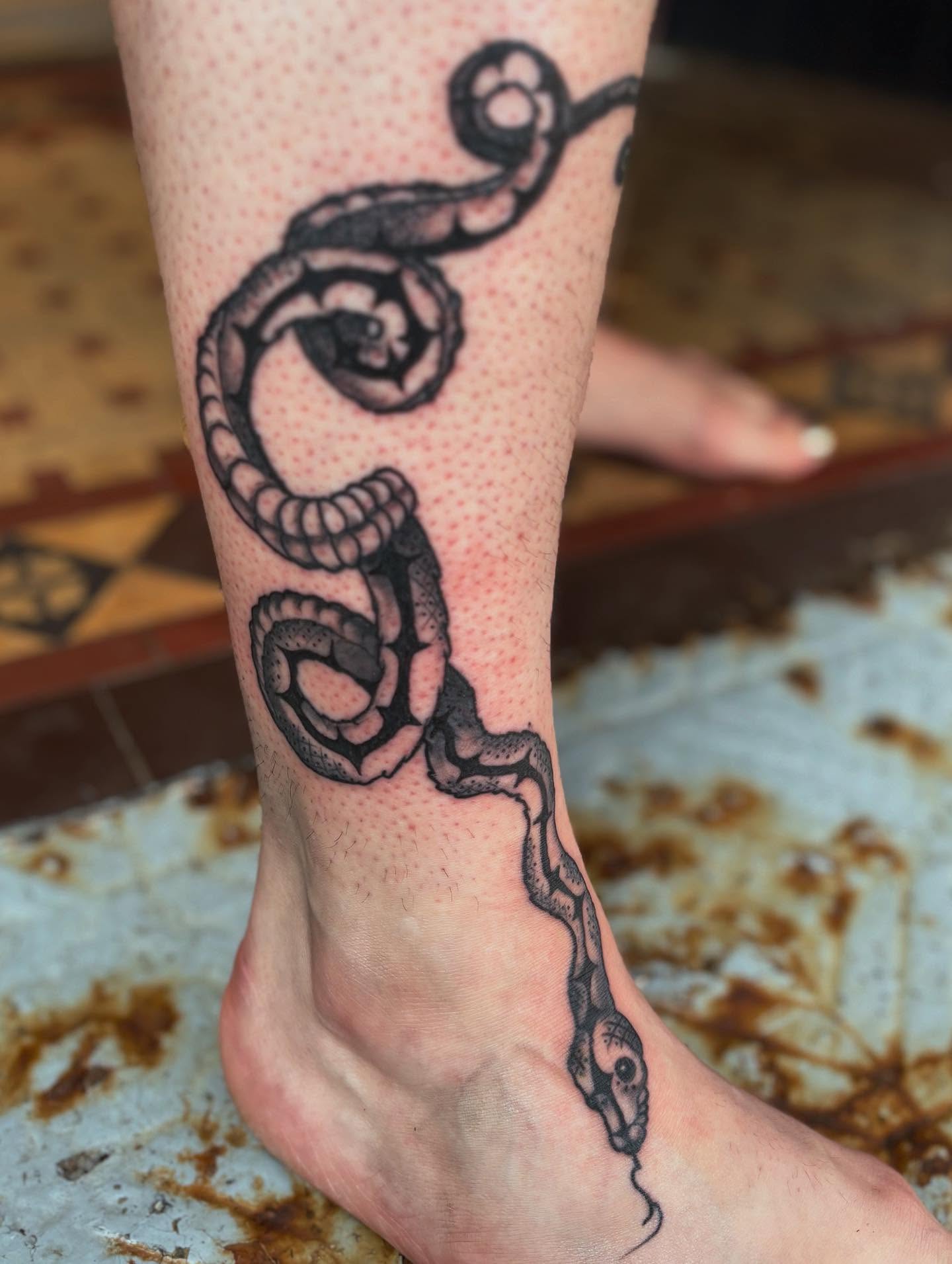 Snake black and grey tattoo on the foot by kris noble floyd