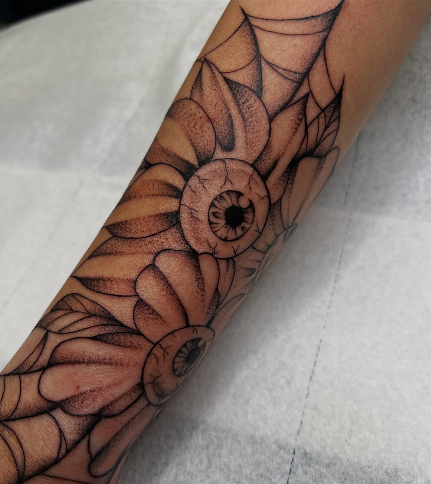 Eye and flower black and grey tattoo on the forearm by Nadia ★