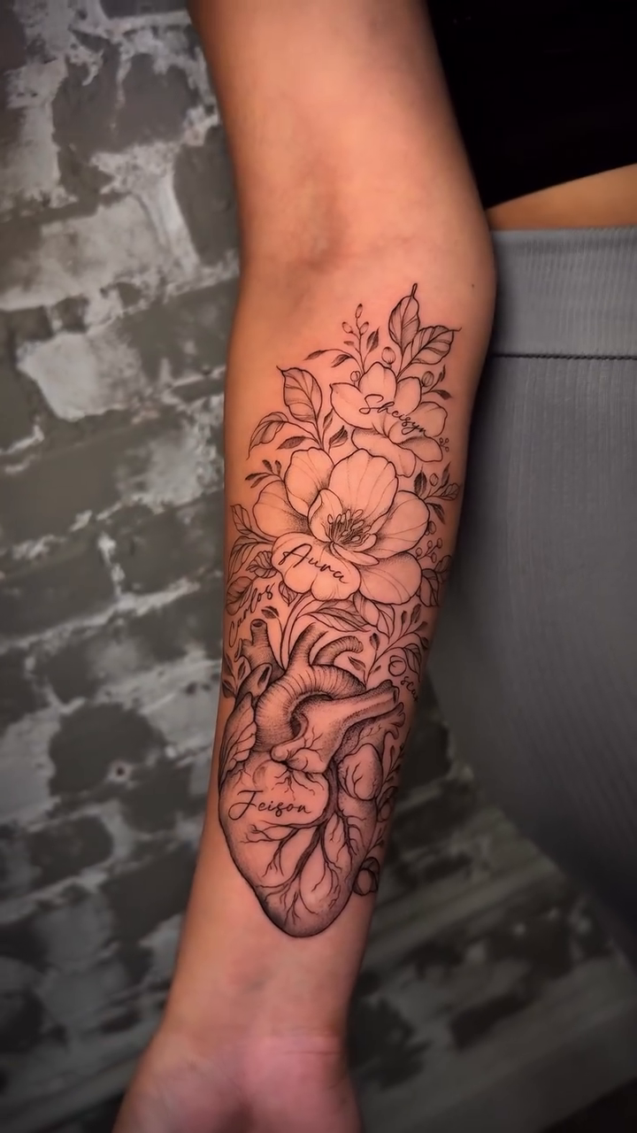 Anatomical heart with flowers fine line tattoo on the forearm by Nyc Tattoo Manhattan