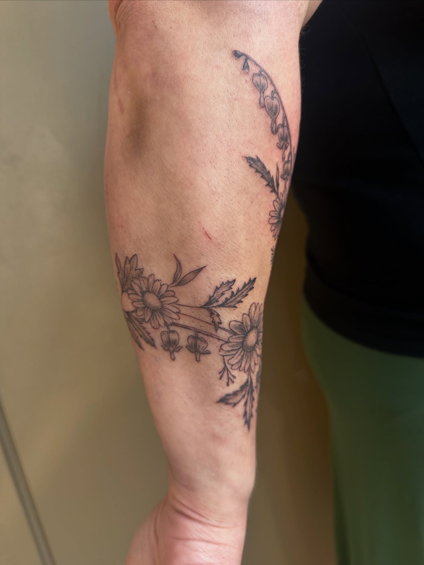 Floral arrangement black and grey tattoo on the forearm by Lauren DeLizza