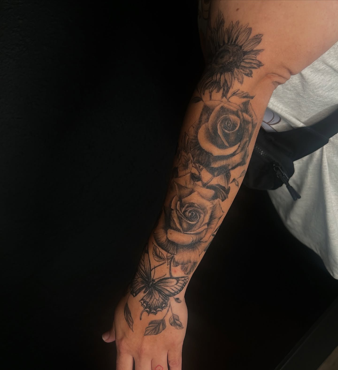 Flowers and butterfly realism tattoo on the forearm by Haley
