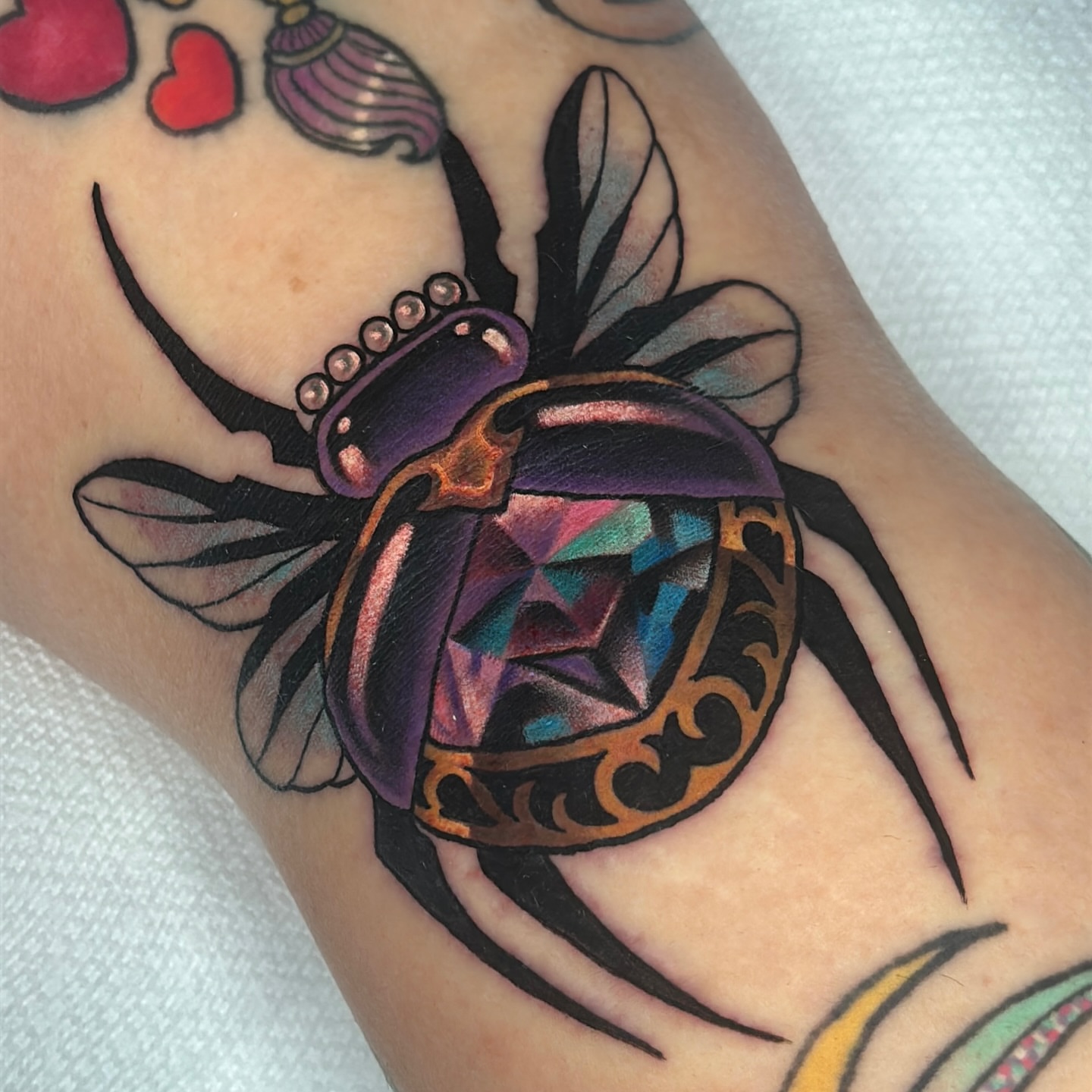 Beetle American traditional tattoo on the forearm by Latesha Burnley