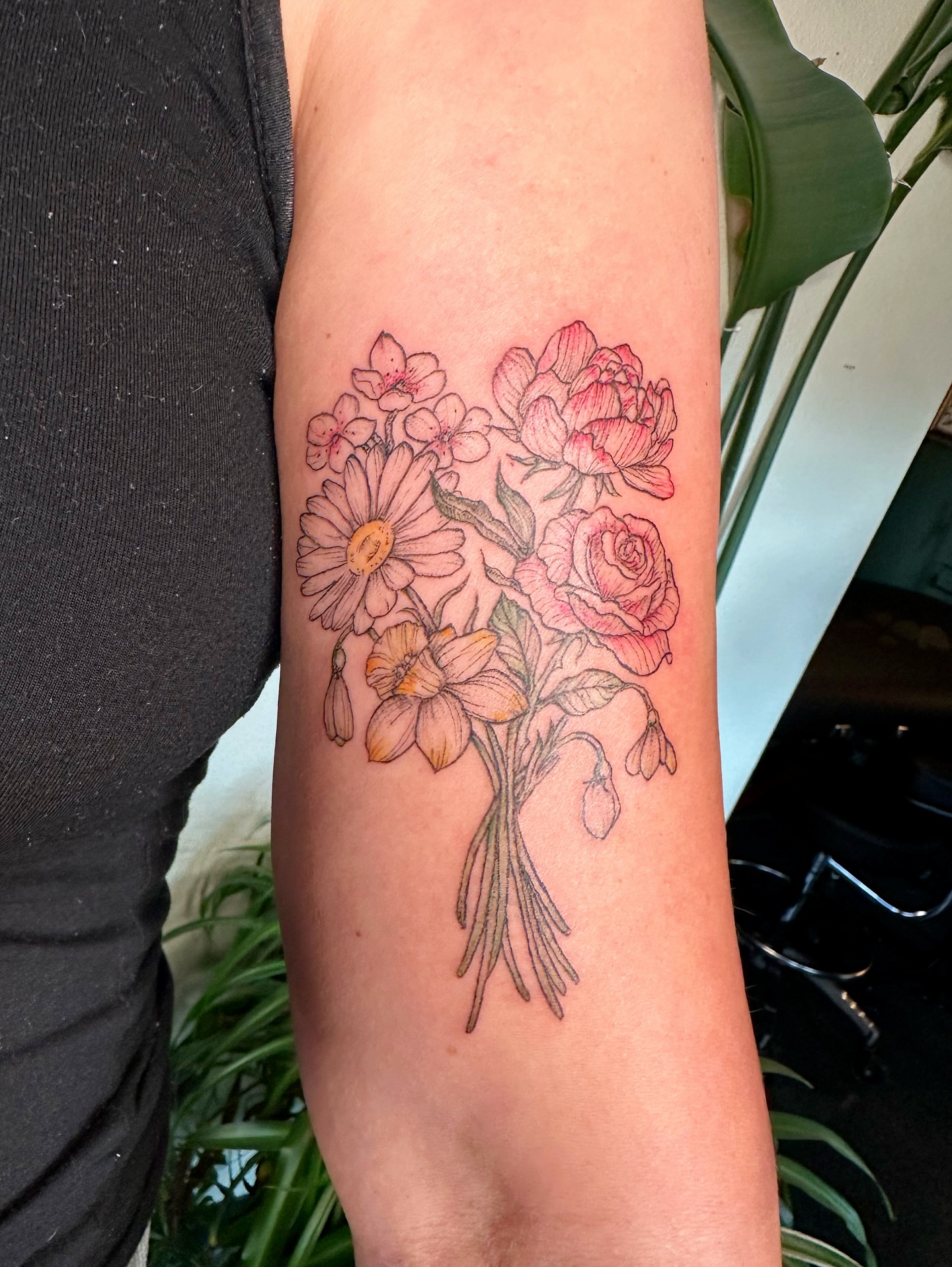 Flower bouquet realism tattoo on the forearm by kenzie hunter