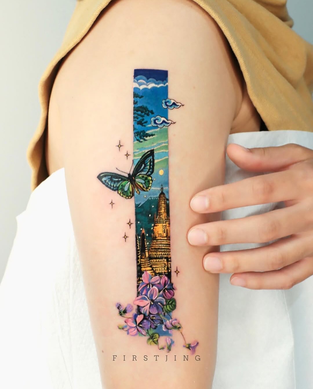 Butterfly and landscape new school tattoo on the upper arm by Seattle