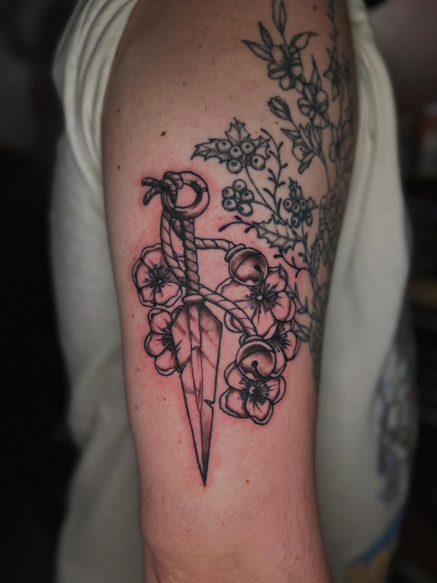 Sword and flowers black and grey tattoo on the forearm by Abby Camacho - Tattoo Artist and Piercer โจ๐