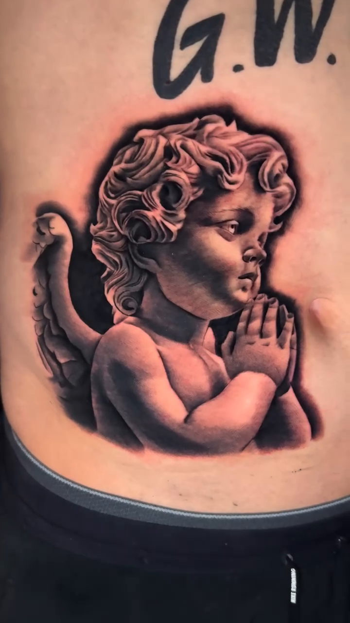 Cherub with praying hands realism tattoo by Kaleb Trujillo
