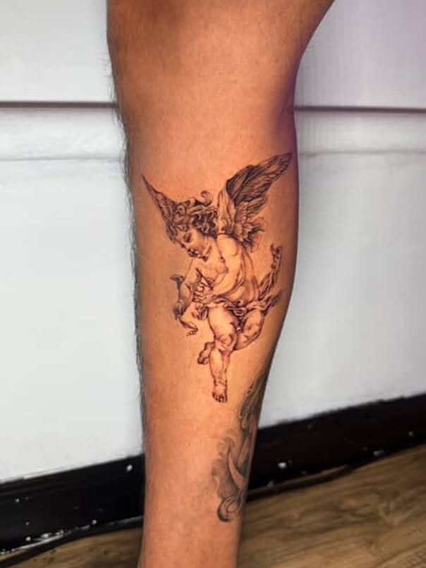 Cherub black and grey tattoo on the calf by aamora ꩜