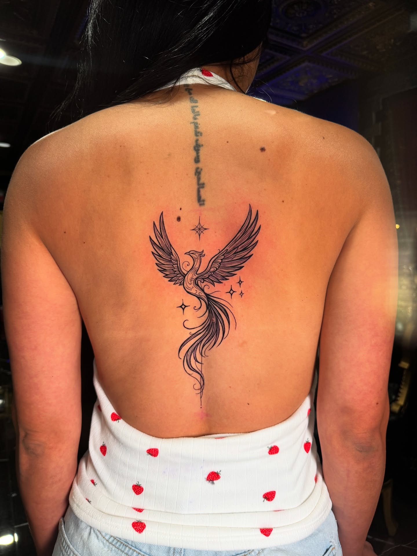 Phoenix neo-traditional tattoo on the back by Juan Carlos