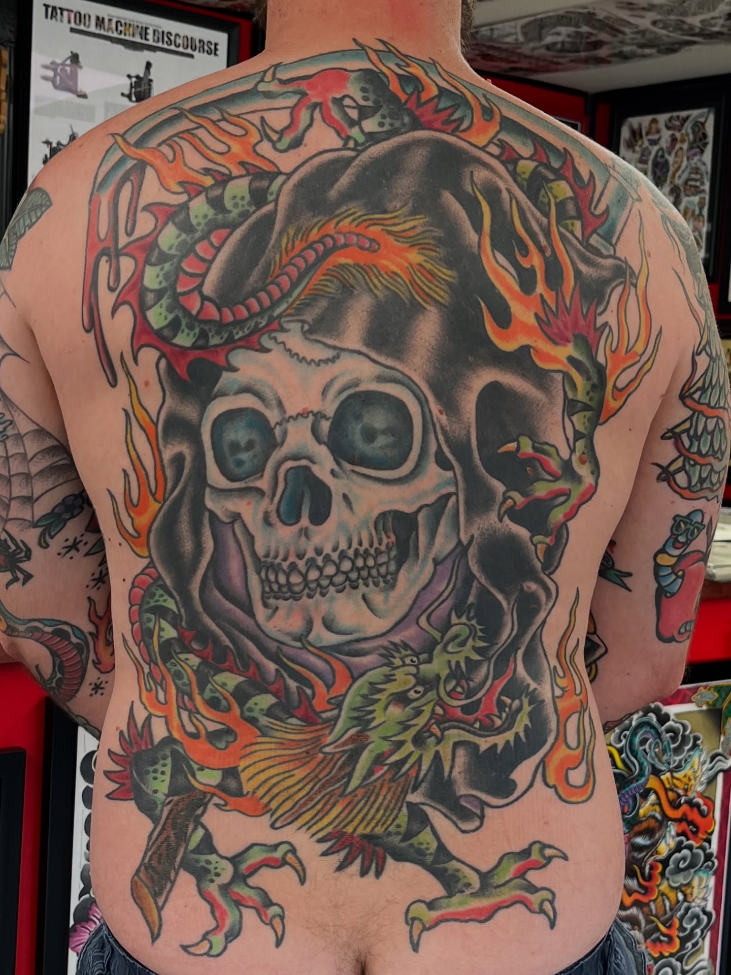 Skull with dragon American traditional tattoo on the back by Steve Tiberi
