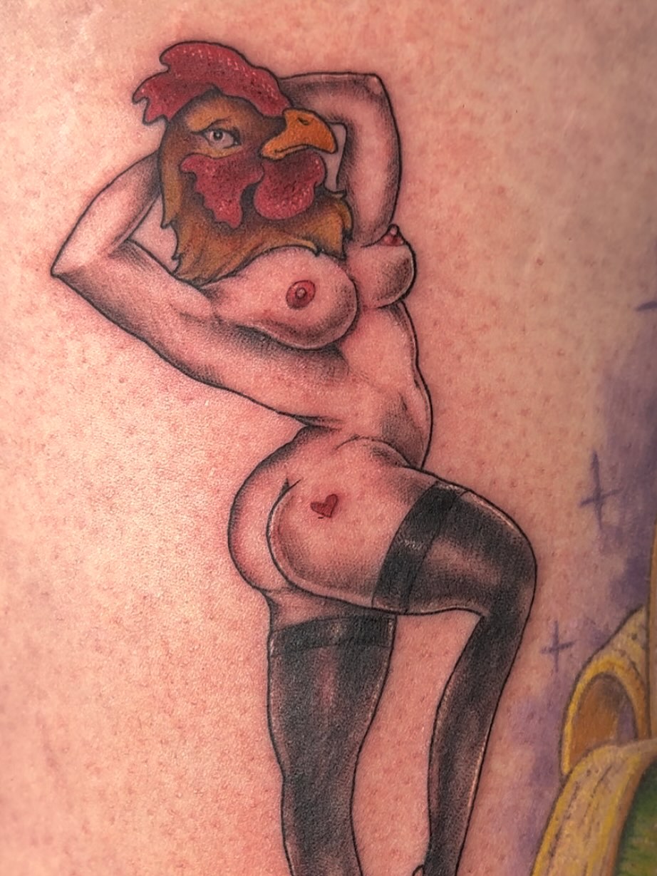 Naked woman with rooster head American traditional tattoo on the thigh by Michele Estes